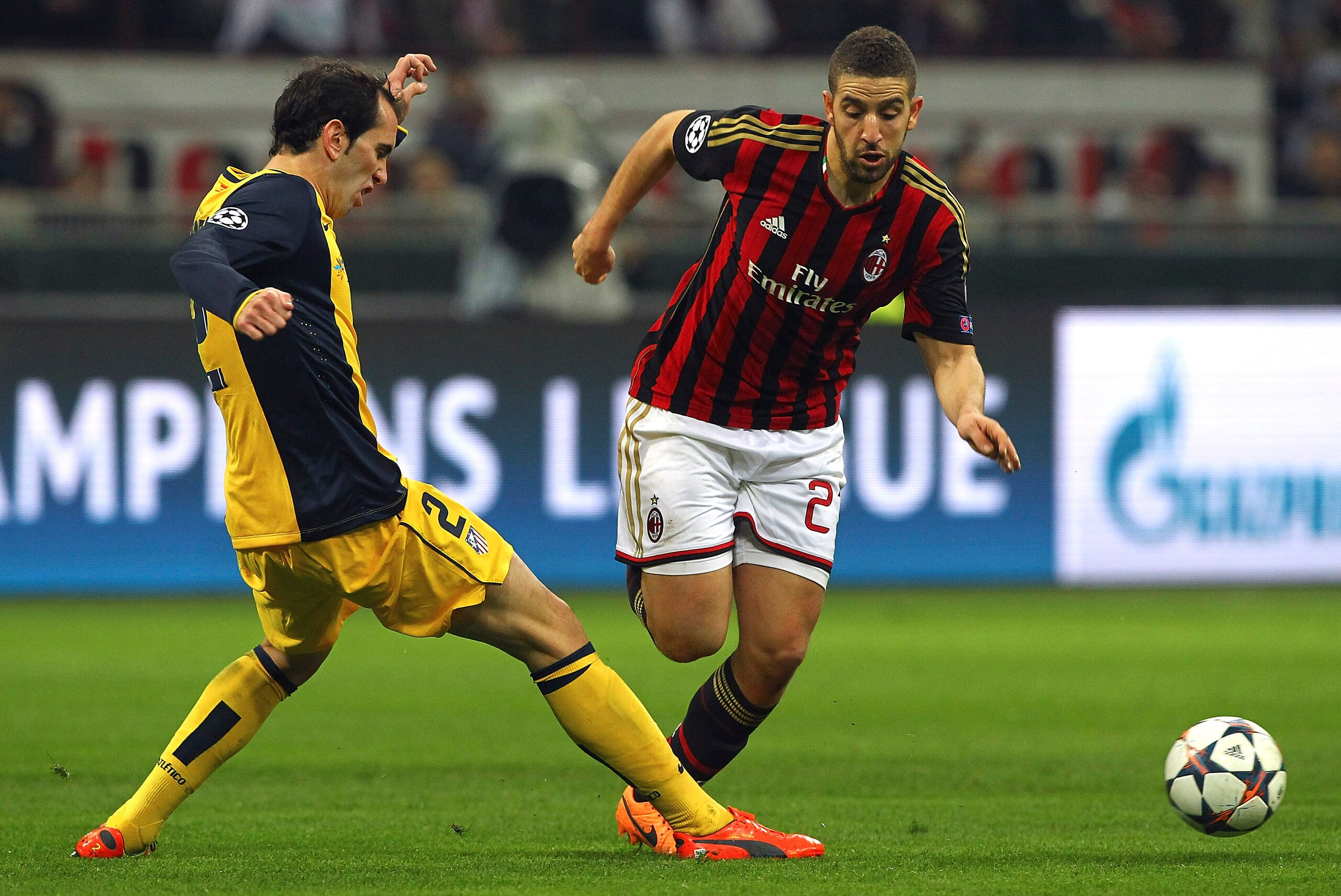 MILAN, ITALY - FEBRUARY 19: Adel Taarabt (R) of AC Milan is challenged by Diego Godin (L) of Club Atletico de Madrid during the UEFA Champions League Round of 16 match between AC Milan and Club Atletico de Madrid at Stadio Giuseppe Meazza on February 19, MILAN, ITALY - FEBRUARY 19: Adel Taarabt (R) of AC Milan is challenged by Diego Godin (L) of Club Atletico de Madrid during the UEFA Champions League Round of 16 match between AC Milan and Club Atletico de Madrid at Stadio Giuseppe Meazza on February 19,