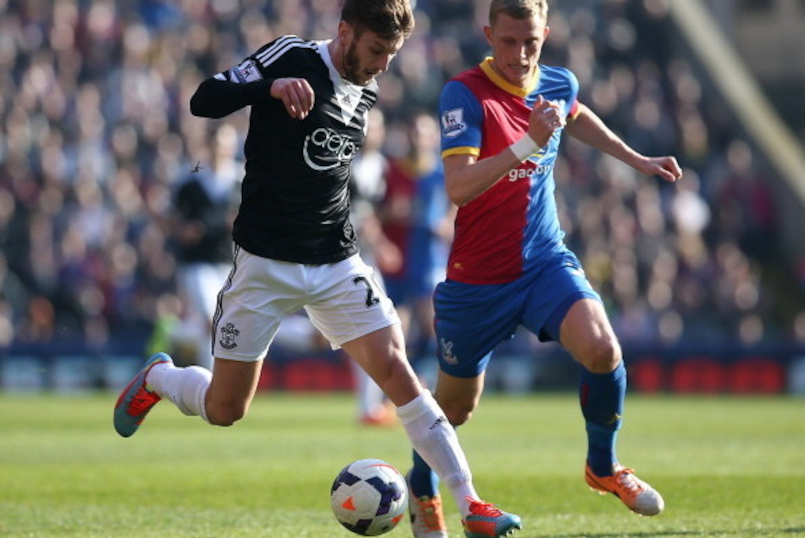 LONDON, ENGLAND - MARCH 08: Adam Lallana of Southampton looks to get away from Palace's Dean Moxey during the Barclays Premier League match between Crystal Palace and Southampton at Selhurst Park on March 08, 2014 in London, England. (Photo by Charlie Cro