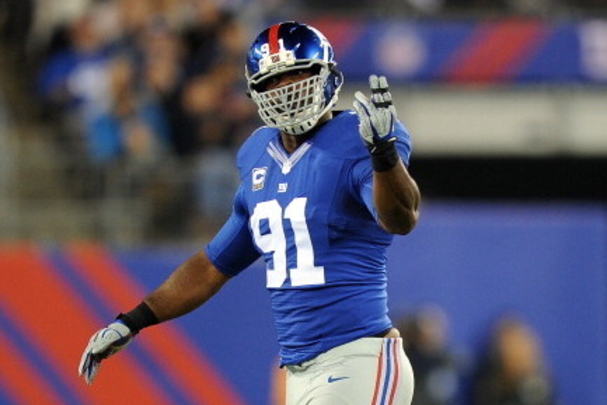 EAST RUTHERFORD, NJ - OCTOBER 21: Defensive end Justin Tuck #91 of the New York Giants reacts after a defensive play against the Minnesota Vikings during a game at MetLife Stadium on October 21, 2013 in East Rutherford, New Jersey.  (Photo by Maddie Meyer