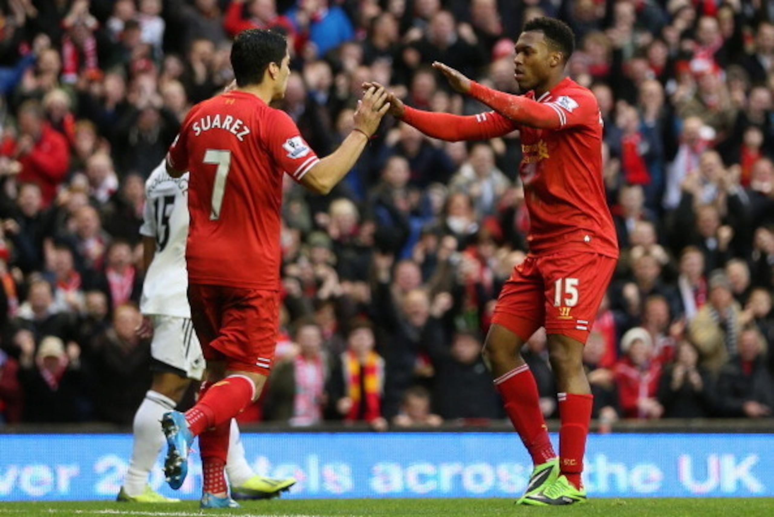 LIVERPOOL, ENGLAND - FEBRUARY 23:  Daniel Sturridge of Liverpool celebrates scoring his team's third goal with Luis Suarez during the Barclays Premier League match between Liverpool and Swansea City at Anfield on February 23, 2014 in Liverpool, England.  
