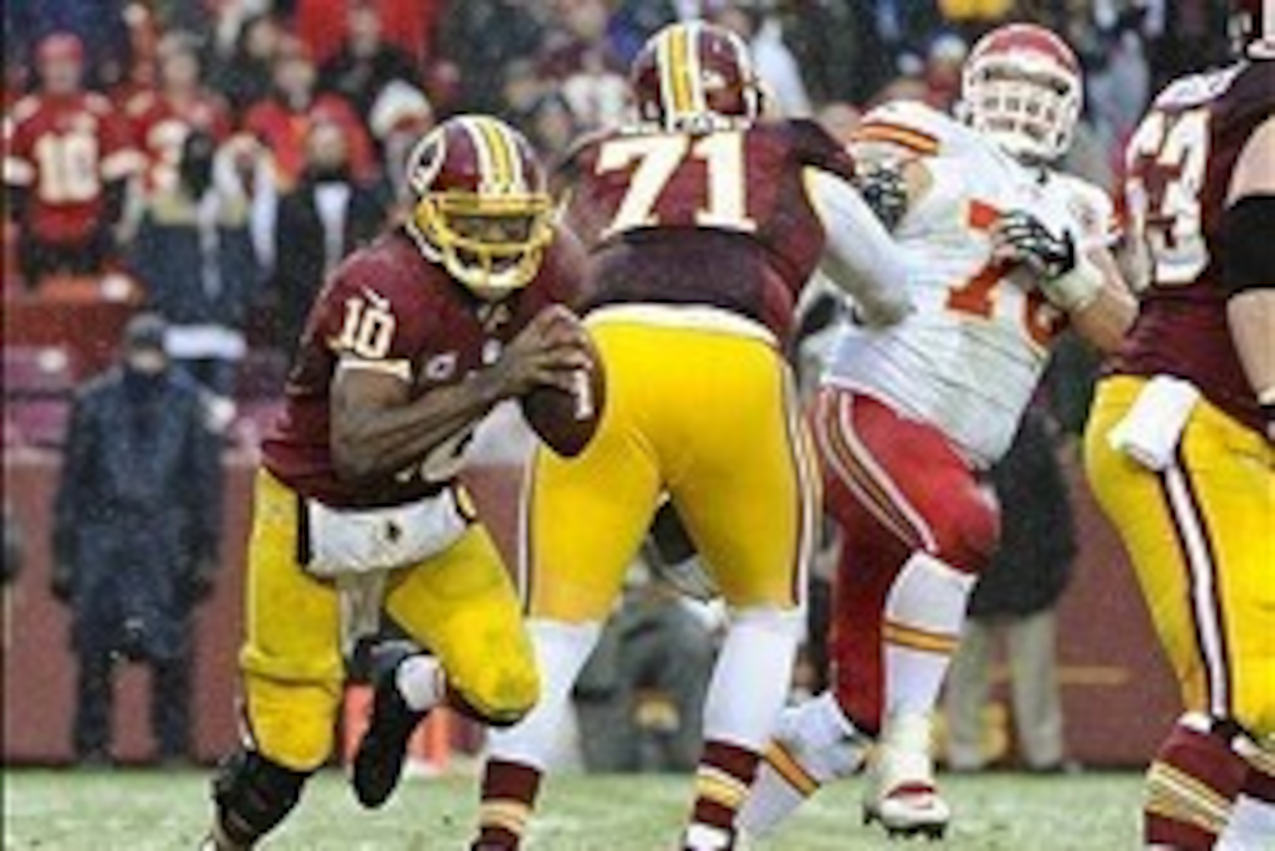 Dec 8, 2013; Landover, MD, USA; Washington Redskins quarterback Robert Griffin III (10) scrambles against the Kansas City Chiefs during the second half at FedEx Field. The Chiefs won 45 - 10. Mandatory Credit: Brad Mills-USA TODAY Sports