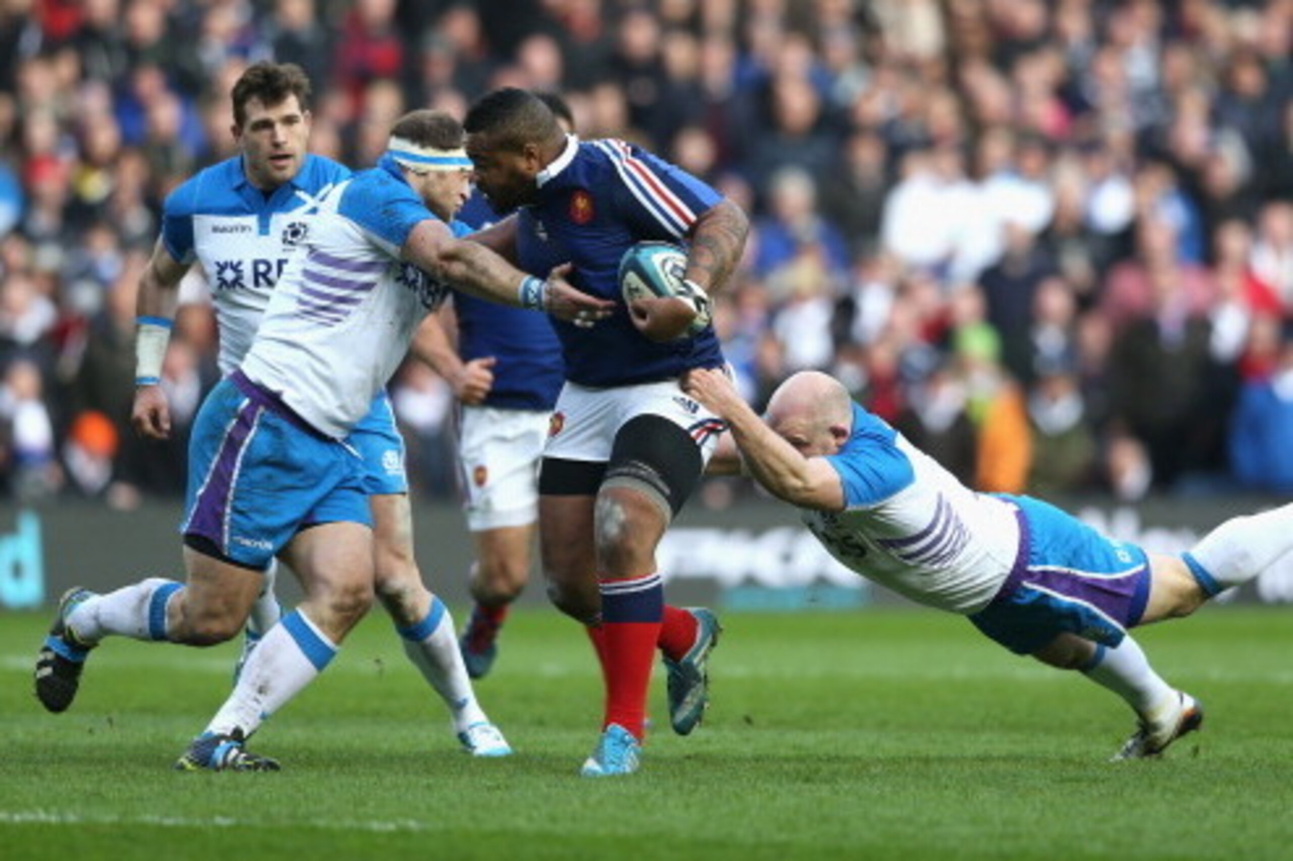 EDINBURGH, SCOTLAND - MARCH 08:  Mathieu Bastareaud of France is tackled by Ryan Grant (L) and Scott Lawson during the RBS Six Nations match between Scotland and France at Murrayfield Stadium on March 8, 2014 in Edinburgh, Scotland.  (Photo by David Roger
