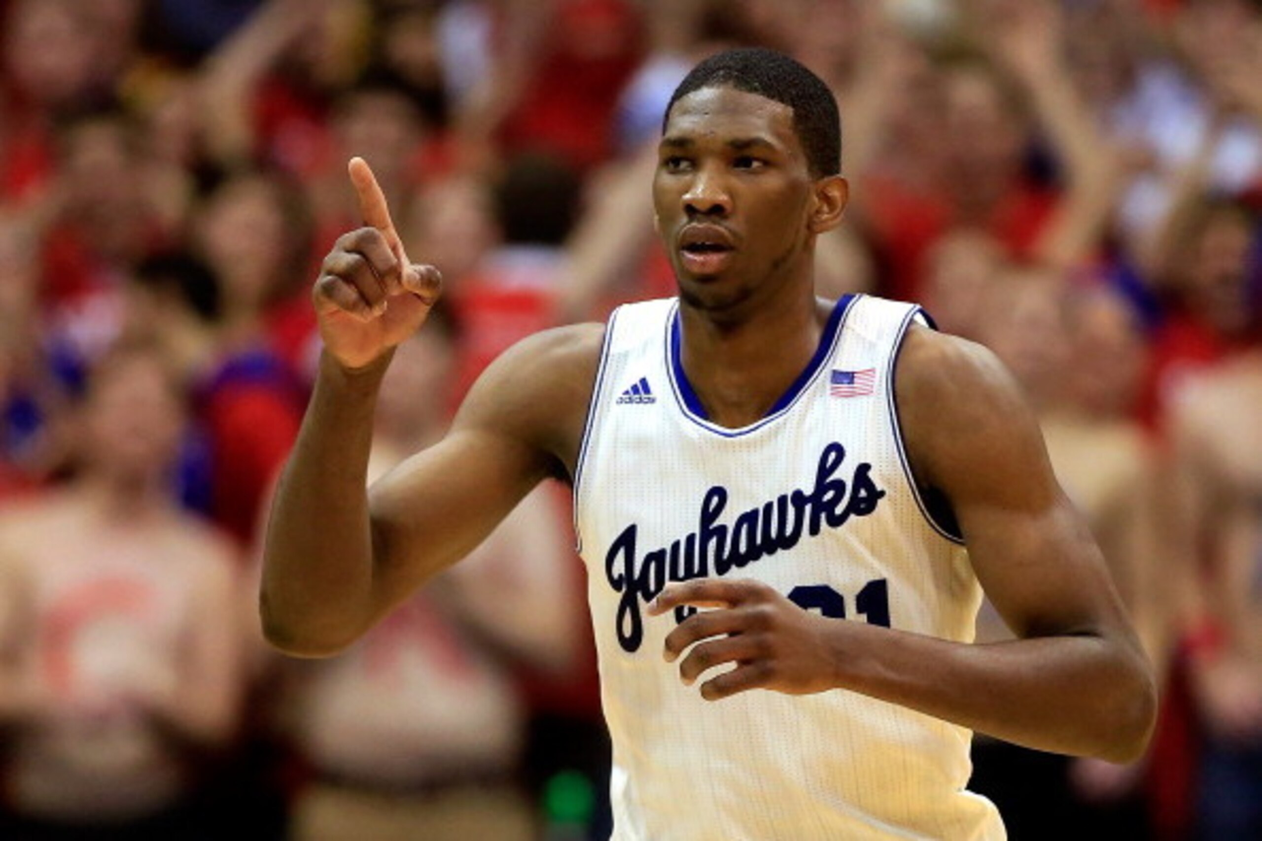 LAWRENCE, KS - JANUARY 18:  Joel Embiid #21 of the Kansas Jayhawks reacts after scoring during the game against the Oklahoma State Cowboys at Allen Fieldhouse on January 18, 2014 in Lawrence, Kansas.  (Photo by Jamie Squire/Getty Images)