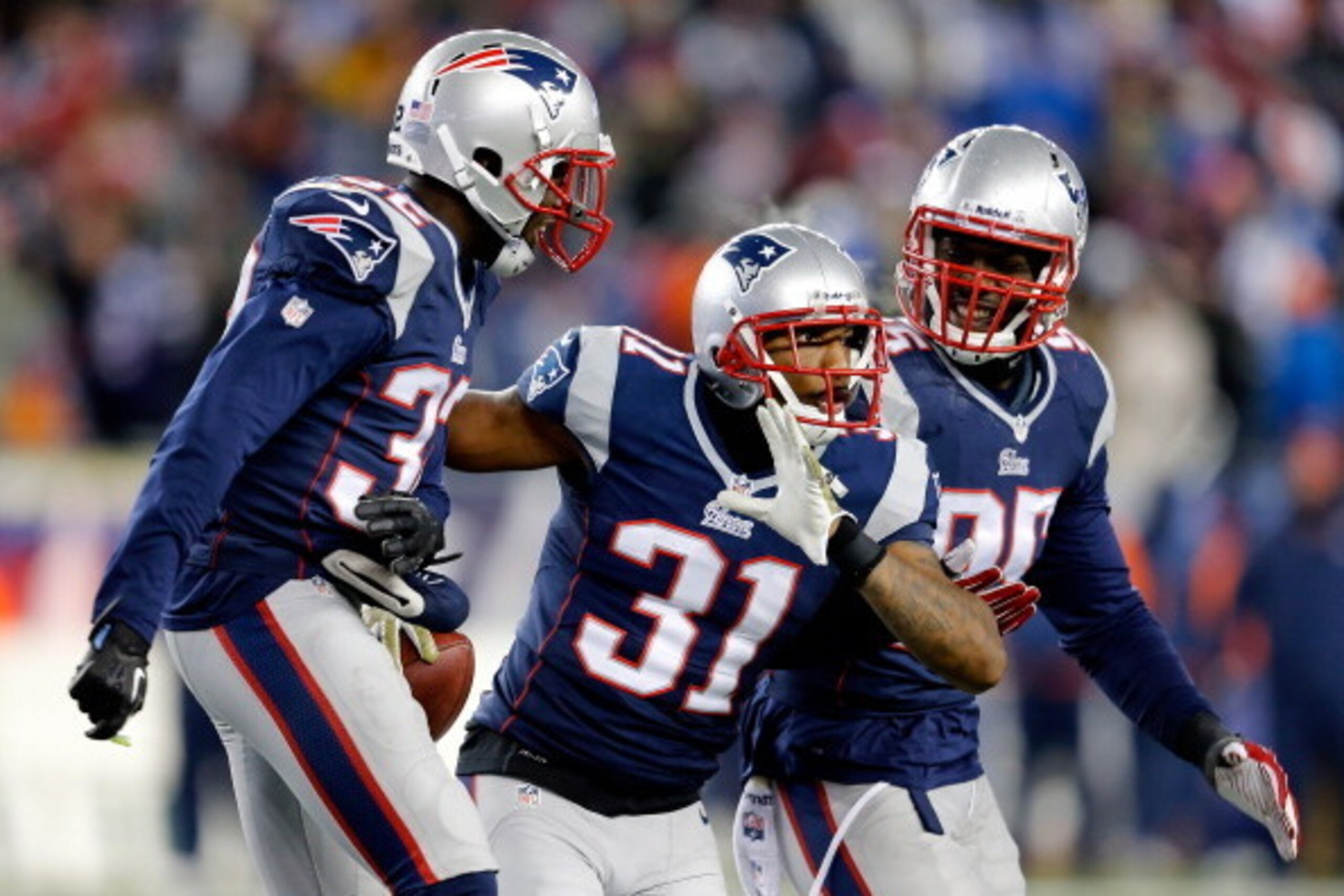 FOXBORO, MA - NOVEMBER 24:  Cornerback Aqib Talib #31, free safety Devin McCourty #32, and defensive end Chandler Jones #95 of the New England Patriots celebrate a defensive play against the Denver Broncos  during a game at Gillette Stadium on November 24