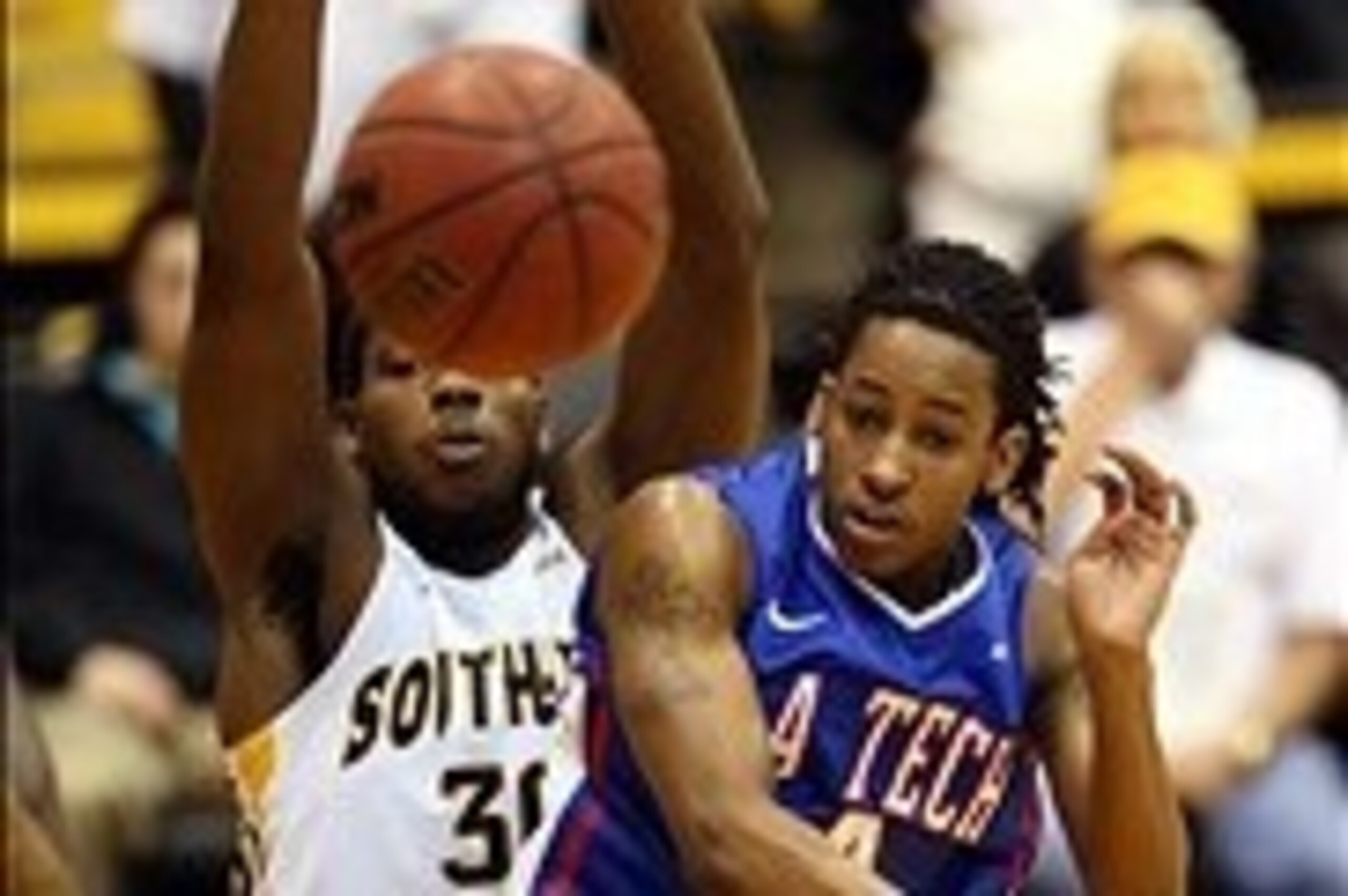 Jan 19, 2014; Hattiesburg, MS, USA; Louisiana Tech Bulldogs guard Kenneth Smith (4) makes a pass while defended by Southern Miss Golden Eagles forward Jeremiah Eason (30) during the first half at Reed Green Coliseum. Mandatory Credit: Chuck Cook-USA TODAY