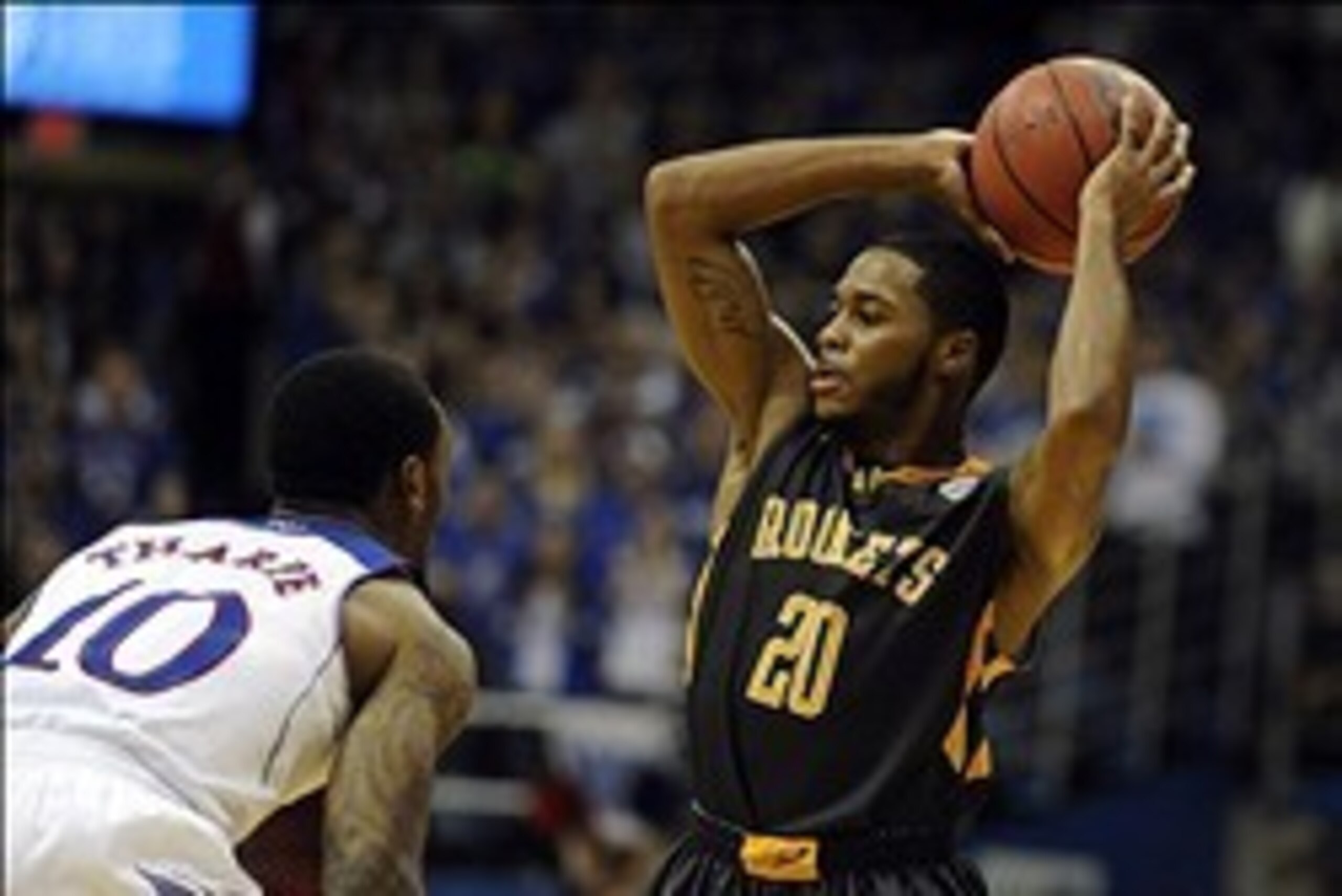 Dec 30, 2013; Lawrence, KS, USA; Toledo Rockets guard Julius Brown (20) passes against Kansas Jayhawks guard Naadir Tharpe (10) in the second half at Allen Fieldhouse. Kansas won 93-83. Mandatory Credit: John Rieger-USA TODAY Sports