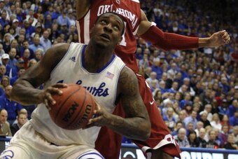 LAWRENCE, KS - FEBRUARY 24:  Tarik Black #25 of the Kansas Jayhawks looks to shoot against Isaiah Cousins #11 of the Oklahoma Sooners in the first half at Allen Fieldhouse on February 24, 2014 in Lawrence, Kansas. (Photo by Ed Zurga/Getty Images)