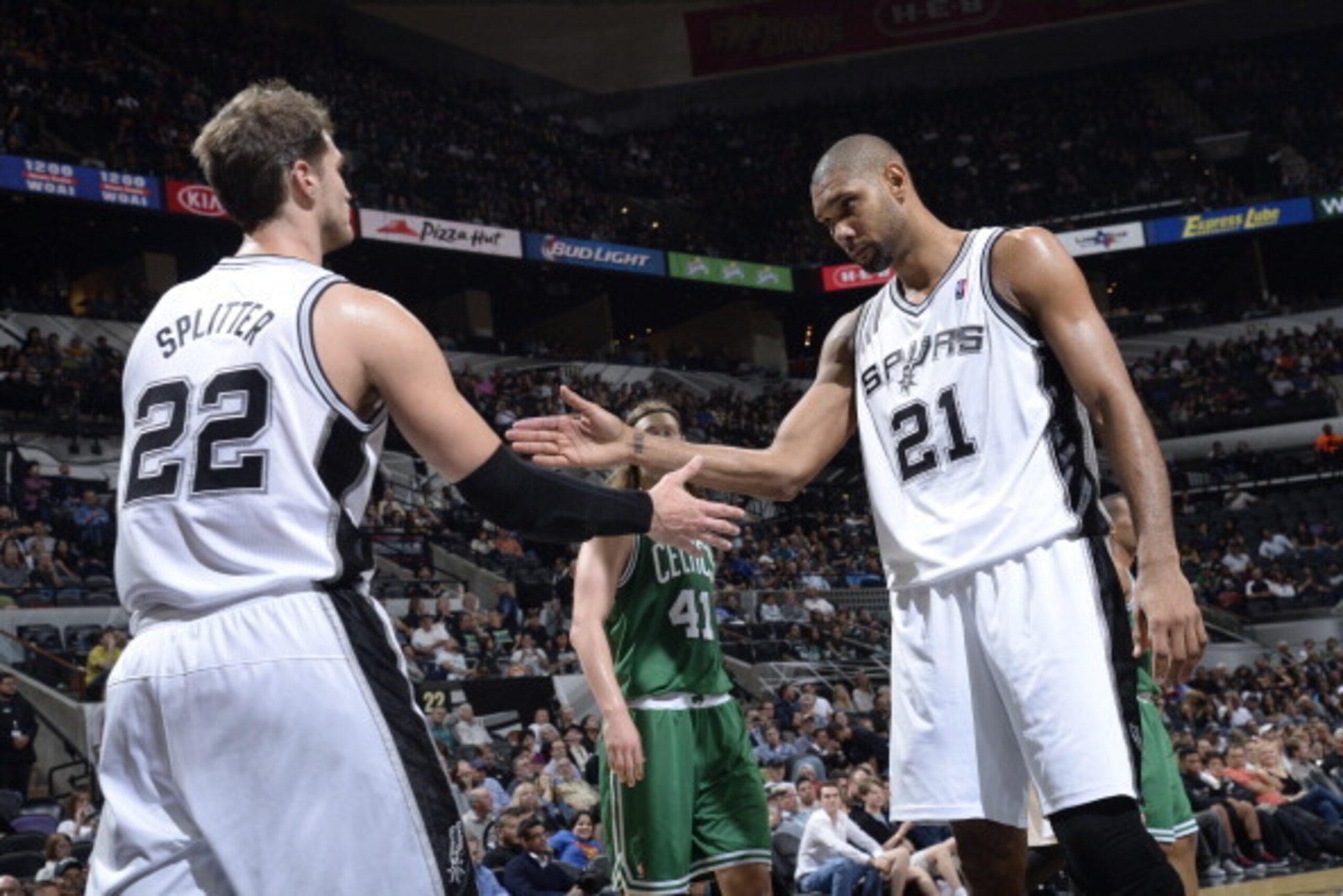 SAN ANTONIO, TX - November 20: Tiago Splitter #22 and Tim Duncan #21 of the San Antonio Spurs celebrate during the game against the Boston Celtics at the AT&T Center on November 20, 2013 in San Antonio, Texas. NOTE TO USER: User expressly acknowledges and