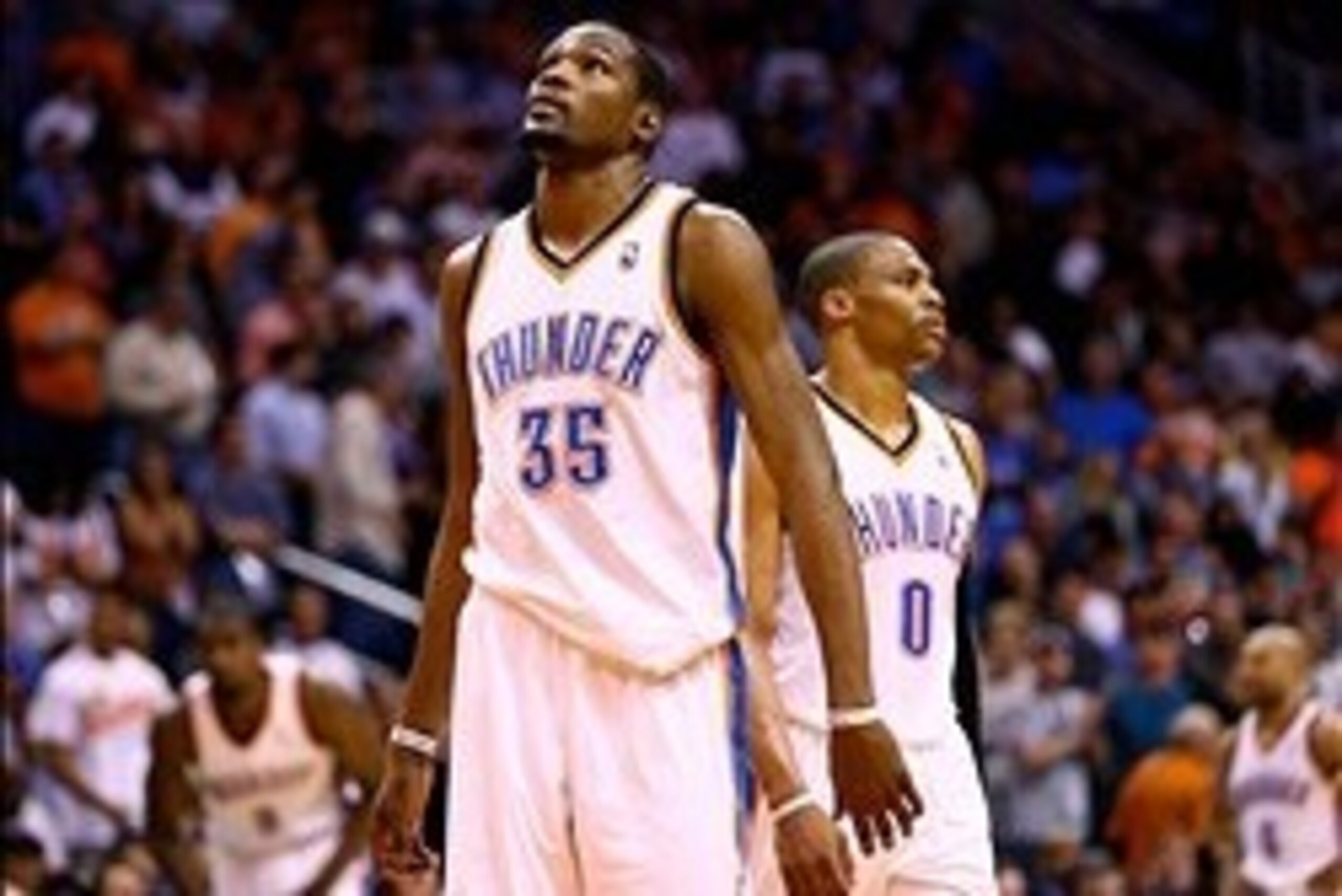 Mar 6, 2014; Phoenix, AZ, USA; Oklahoma City Thunder forward Kevin Durant (35) and guard Russell Westbrook (0) react during the fourth quarter against the Phoenix Suns at the US Airways Center. The Suns defeated the Thunder 128-122. Mandatory Credit: Mark