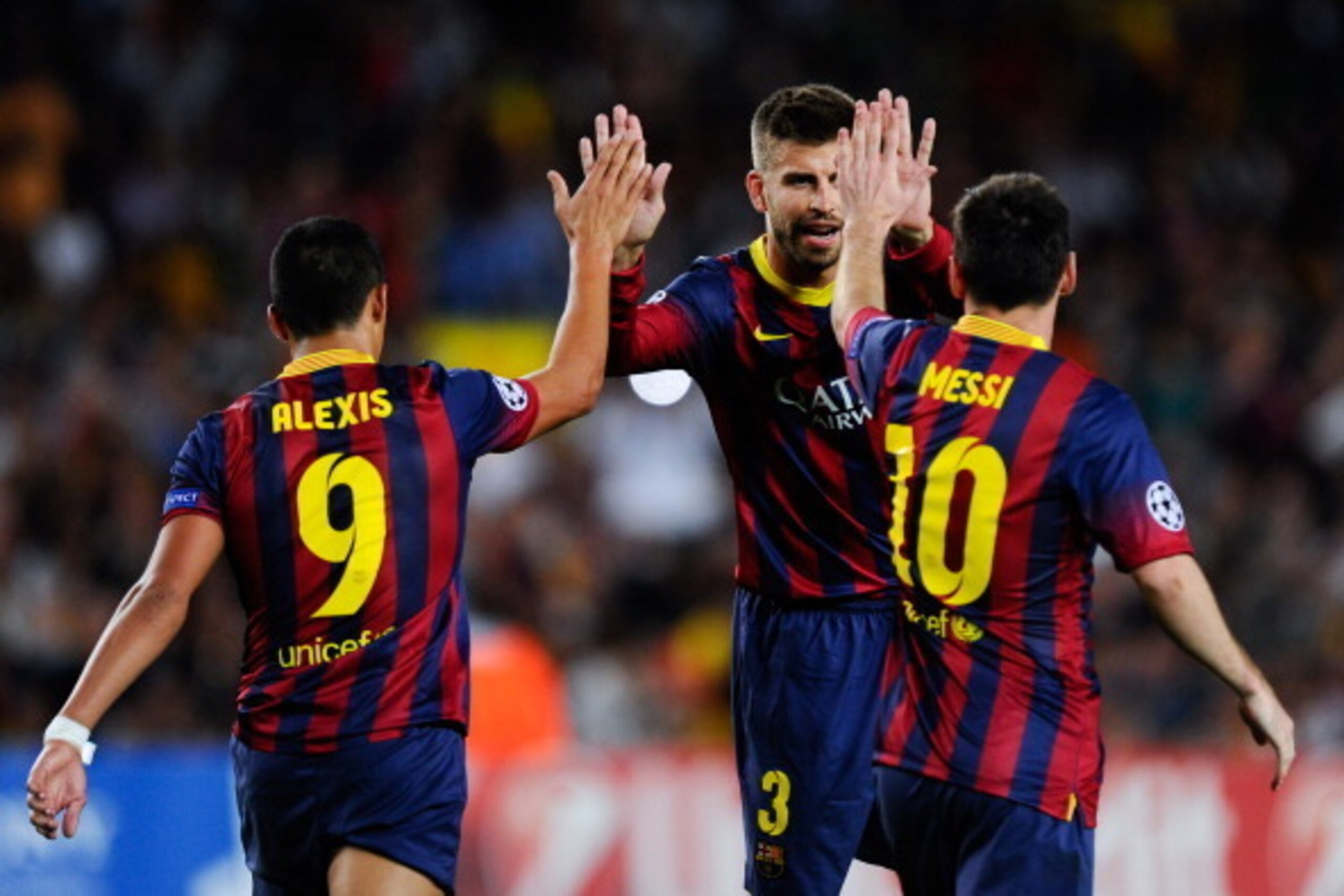 BARCELONA, SPAIN - SEPTEMBER 18:  Lionel Messi (R) of FC Barcelona celebrates with his team-mates Gerard Pique (C) and Alexis Sanchez after scoring his team's second goal during the UEFA Champions League Group H match between FC Barcelona and Ajax Amsterd