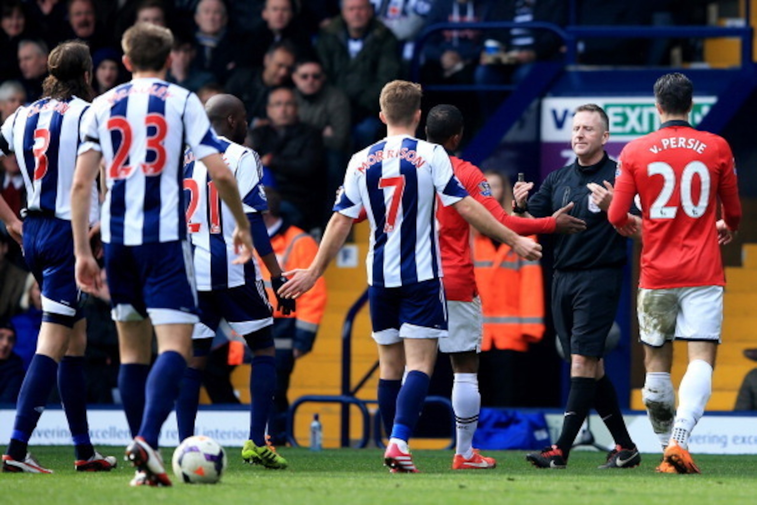 WEST BROMWICH, ENGLAND - MARCH 08:  Referee Jonathan Moss signals to Youssuf Mulumbu (21) and James Morrison of West Bromwich Albion (7) and Patrice Evra (3R) and Robin van Persie of Manchester United (20) during the Barclays Premier League match between 