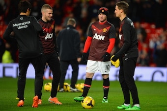 MANCHESTER, ENGLAND - JANUARY 28:  Wayne Rooney of Manchester United warms up with Tom Cleverley (L) and Adnan Januzaj (R) prior to the Barclays Premier League match between Manchester United and Cardiff City at Old Trafford on January 28, 2014 in Manches