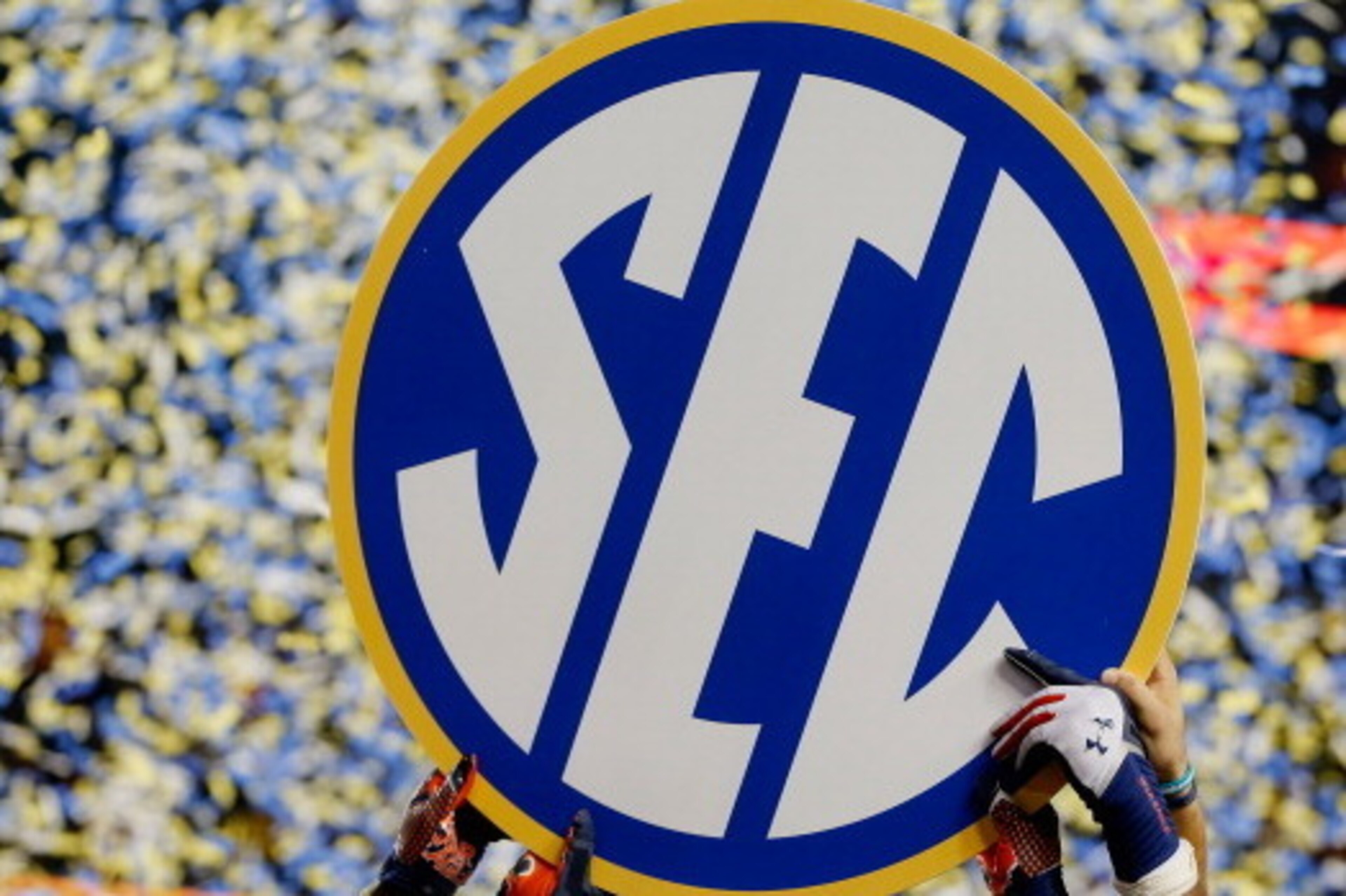 ATLANTA, GA - DECEMBER 07:  The Auburn Tigers hold up the SEC sign in celebration after defeating the Missouri Tigers 59-42 to win the SEC Championship Game at Georgia Dome on December 7, 2013 in Atlanta, Georgia.  (Photo by Kevin C. Cox/Getty Images)