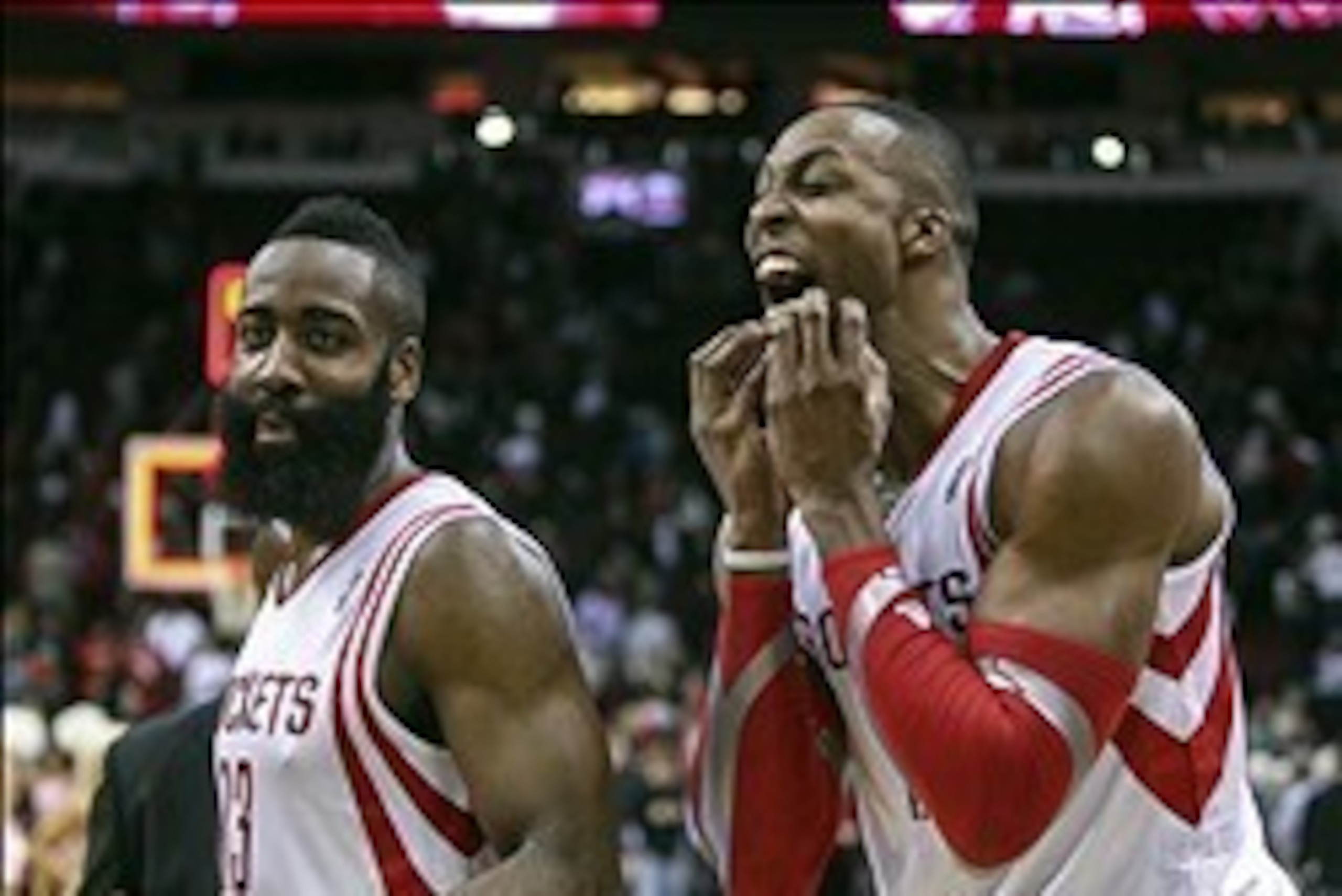Feb 12, 2014; Houston, TX, USA; Houston Rockets shooting guard James Harden (13) and center Dwight Howard (12) react after defeating the Washington Wizards 113-112 at Toyota Center. Mandatory Credit: Troy Taormina-USA TODAY Sports