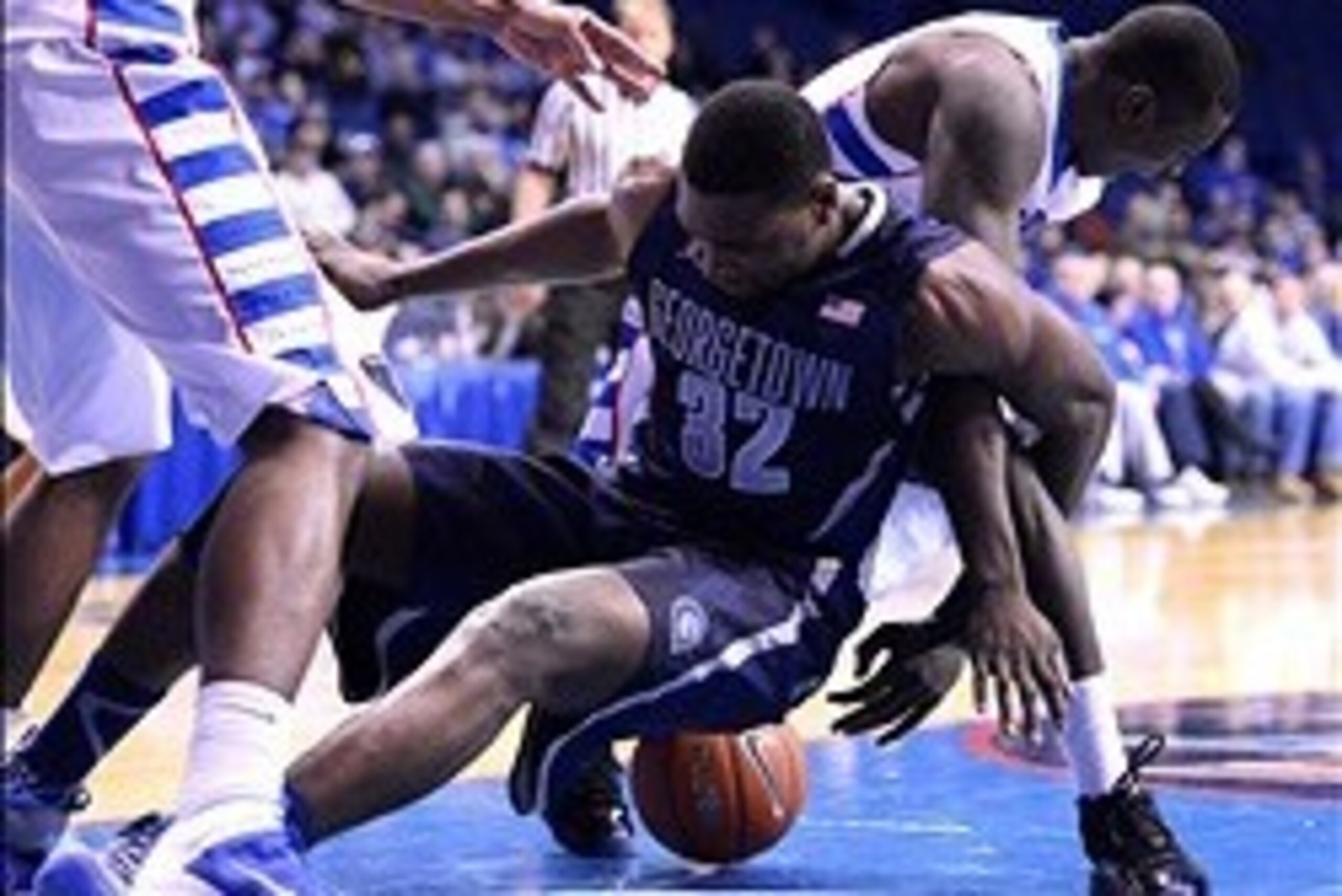 Feb 3, 2014; Rosemont, IL, USA; Georgetown Hoyas center Moses Ayegba (32) and DePaul Blue Demons guard Charles McKinney (32) attempt to get a loose ball during the second half at Allstate Arena. Georgetown defeats DePaul 71-59. Mandatory Credit: Mike DiNo