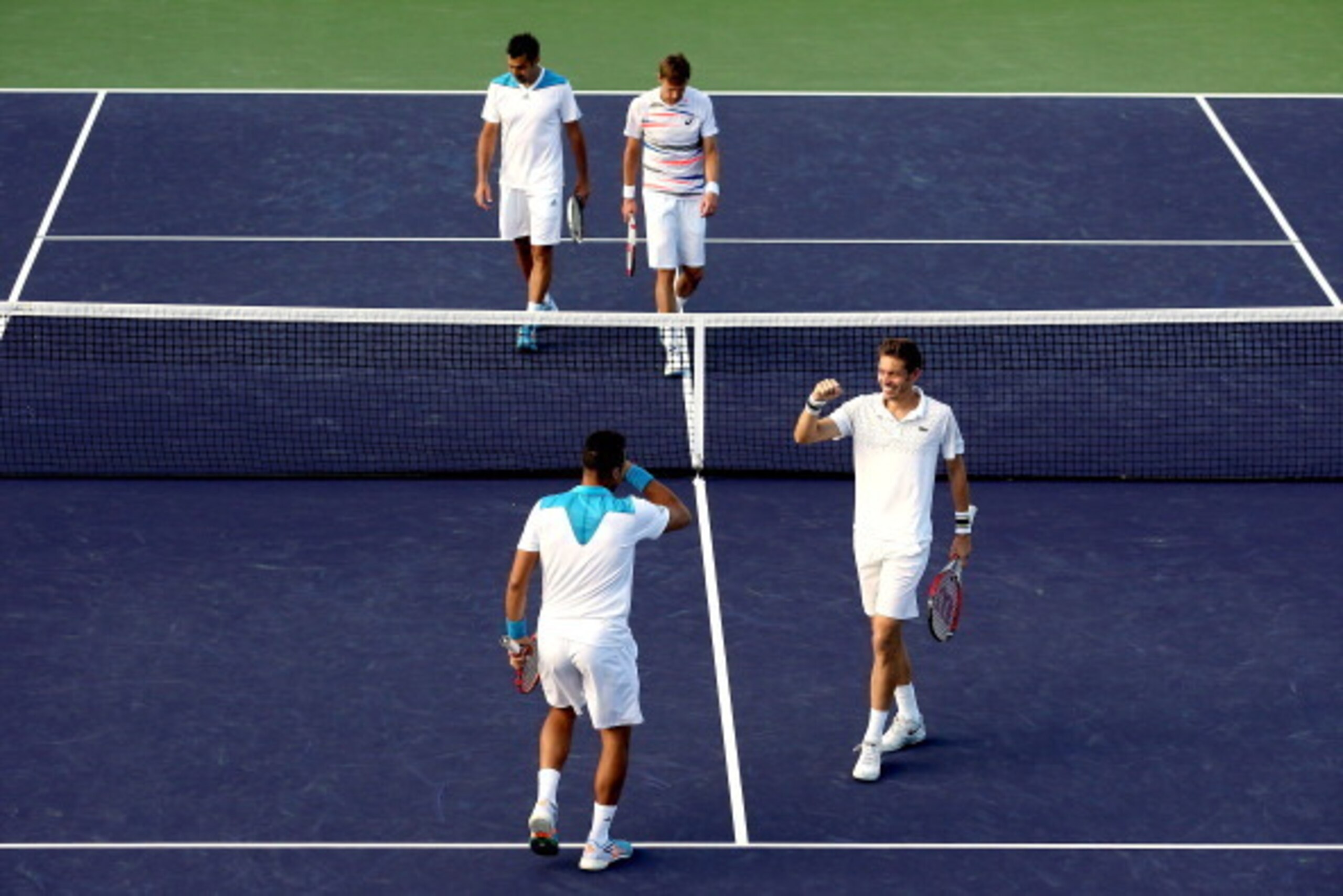 INDIAN WELLS, CA - MARCH 10:  Jo-Wilfried Tsonga  and Nicolas Mahut of France celebrate their win over Nenad Zimonjic of Serbia and Daniel Nestor of Canada during the BNP Parabas Open at the Indian Wells Tennis Garden on March 10, 2014 in Indian Wells, Ca