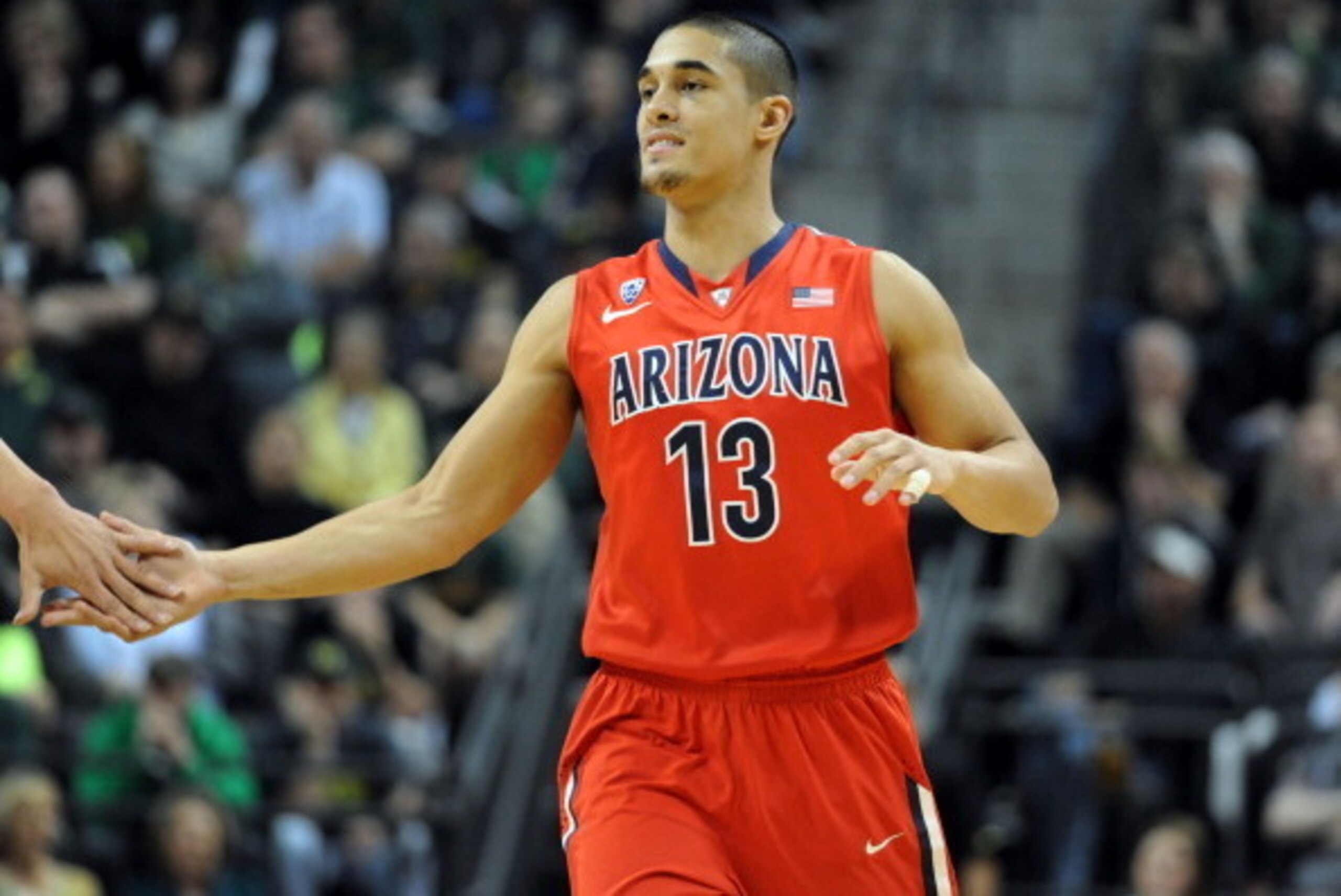 EUGENE, OR - MARCH 8:  Nick Johnson #13 of the Arizona Wildcats is greeted at the bench during the first half of the game against the Oregon Ducks at Matthew Knight Arena on March 8, 2014 in Eugene, Oregon.  (Photo by Steve Dykes/Getty Images)