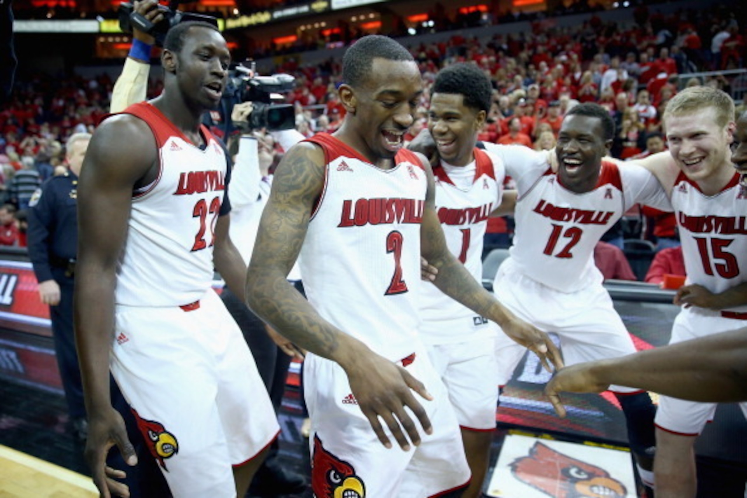 LOUISVILLE, KY - MARCH 08:  Russ Smith #2 of the Louisville Cardinals celebrates with teammates after the game against the Connecticut Huskies at KFC YUM! Center on March 8, 2014 in Louisville, Kentucky.  It was senior day and it was Smith's last home gam