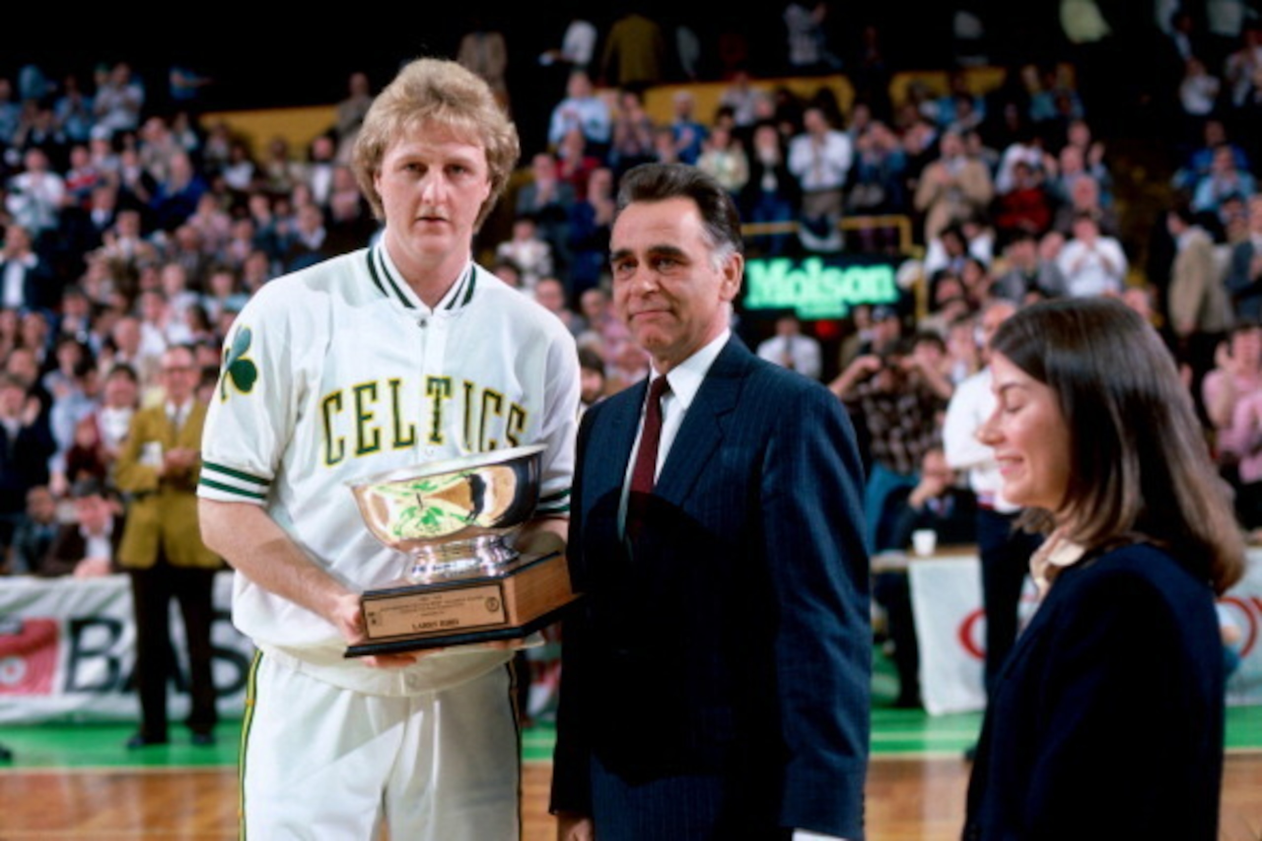 BOSTON, MA - 1984: Larry Bird #33 of the Boston Celtics is awarded the trophy for Most Valuable Player of the Boston Celtics, an honor voted on by the New England press, before a game circa 1984 at the Boston Garden in Boston, Massachusetts. NOTE TO USER: