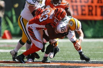 CINCINNATI, OH - SEPTEMBER 22:  Michael Johnson #93 of the Cincinnati Bengals sacks Aaron Rodgers #12 of the Green Bay Packers during their game at Paul Brown Stadium on September 22, 2013 in Cincinnati, Ohio.  The Bengals defeated the Packers 34-30. (Pho
