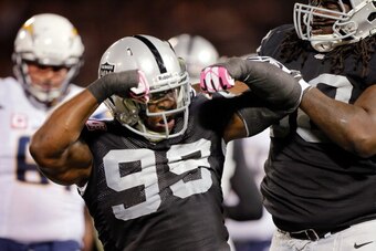 OAKLAND, CA - OCTOBER 06:  Defensive end Lamarr Houston #99 of the Oakland Raiders celebrates a tackle against the San Diego Chargers in the first quarter on October 06, 2013 at O.co Coliseum in Oakland, California.   The Raider lead 14-0 in the first qua