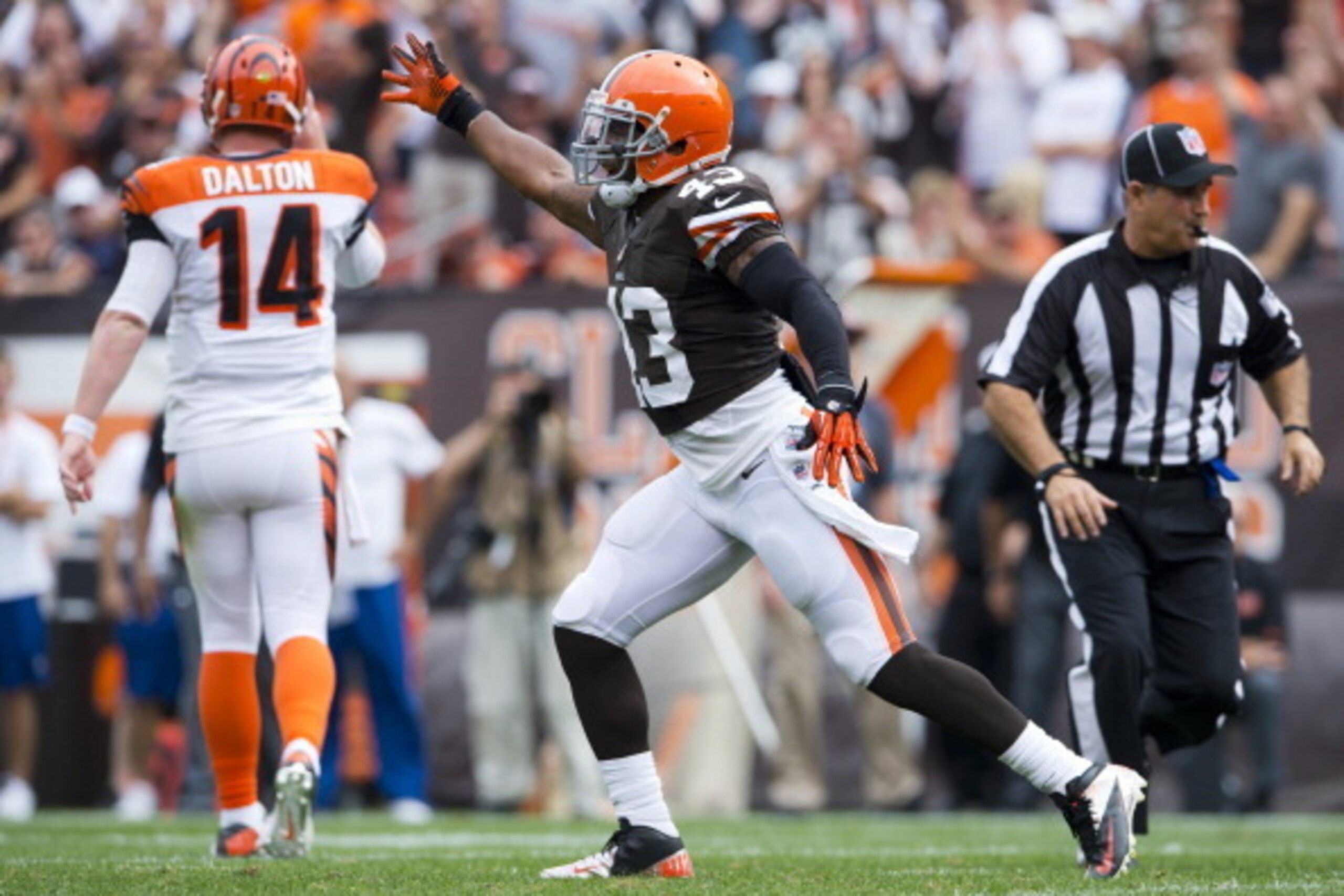 CLEVELAND, OH - SEPTEMBER 29: Quarterback Andy Dalton #14 of the Cincinnati Bengals walks away from the play as strong safety T.J. Ward #43 of the Cleveland Browns celebrate after the Browns stopped the Bengals on fourth down during the first half at Firs