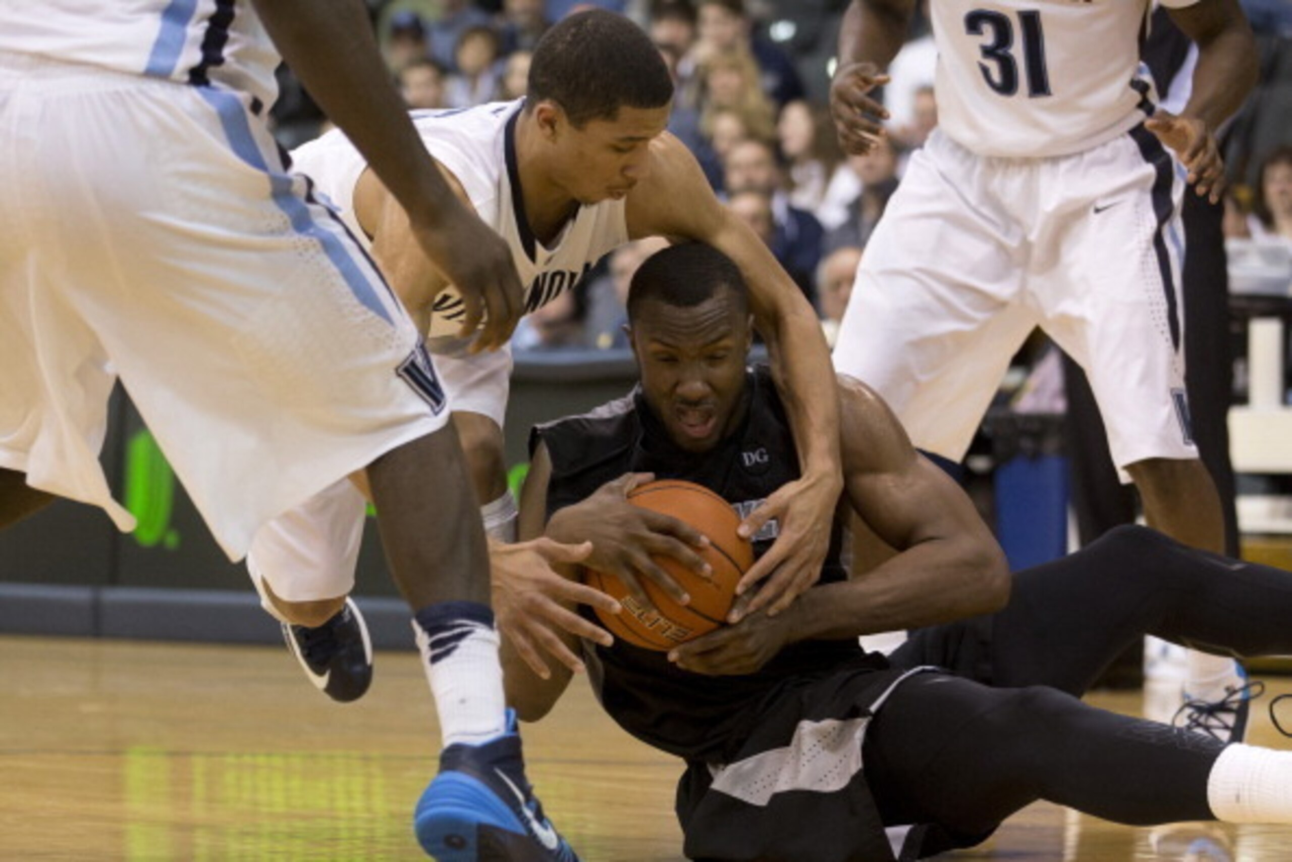 VILLANOVA, PA - JANUARY 5: Forward Kadeem Batts #10 of the Providence Friars holds on to the ball with guard Josh Hart #3 of the Villanova Wildcats reaching in on January 5, 2014 at the Pavilion in Villanova, Pennslyvania. (Photo by Mitchell Leff/Getty Im
