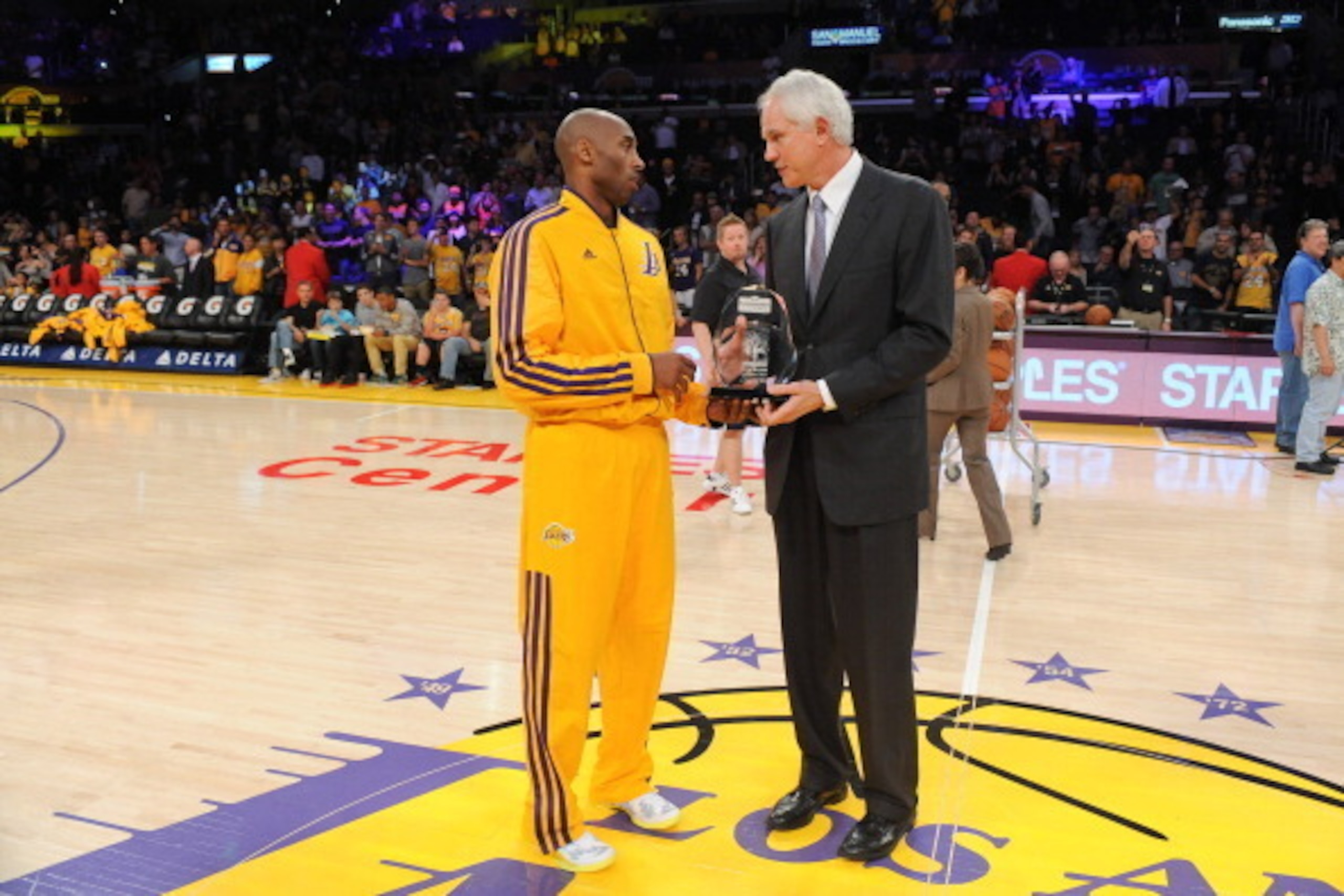 LOS ANGELES, CA - MARCH 22: Kobe Bryant #24 of the Los Angeles Lakers is presented with the Kia Western Conference player of the month award for February 2013 by general manager Mitch Kupchak before their team's game against the Washington Wizards at Stap