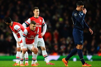LONDON, ENGLAND - FEBRUARY 12:  Jack Wilshere (L) of Arsenal and Robin van Persie (R) of Manchester United react during the Barclays Premier League match between Arsenal and Manchester United at the Emirates Stadium on February 12, 2014 in London, England
