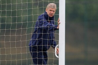 ST ALBANS, ENGLAND - MARCH 10:  Arsenal manager Arsene Wenger moves the goalposts during the Arsenal training session at London Colney on March 10, 2014 in St Albans, England.  (Photo by Michael Regan/Getty Images)