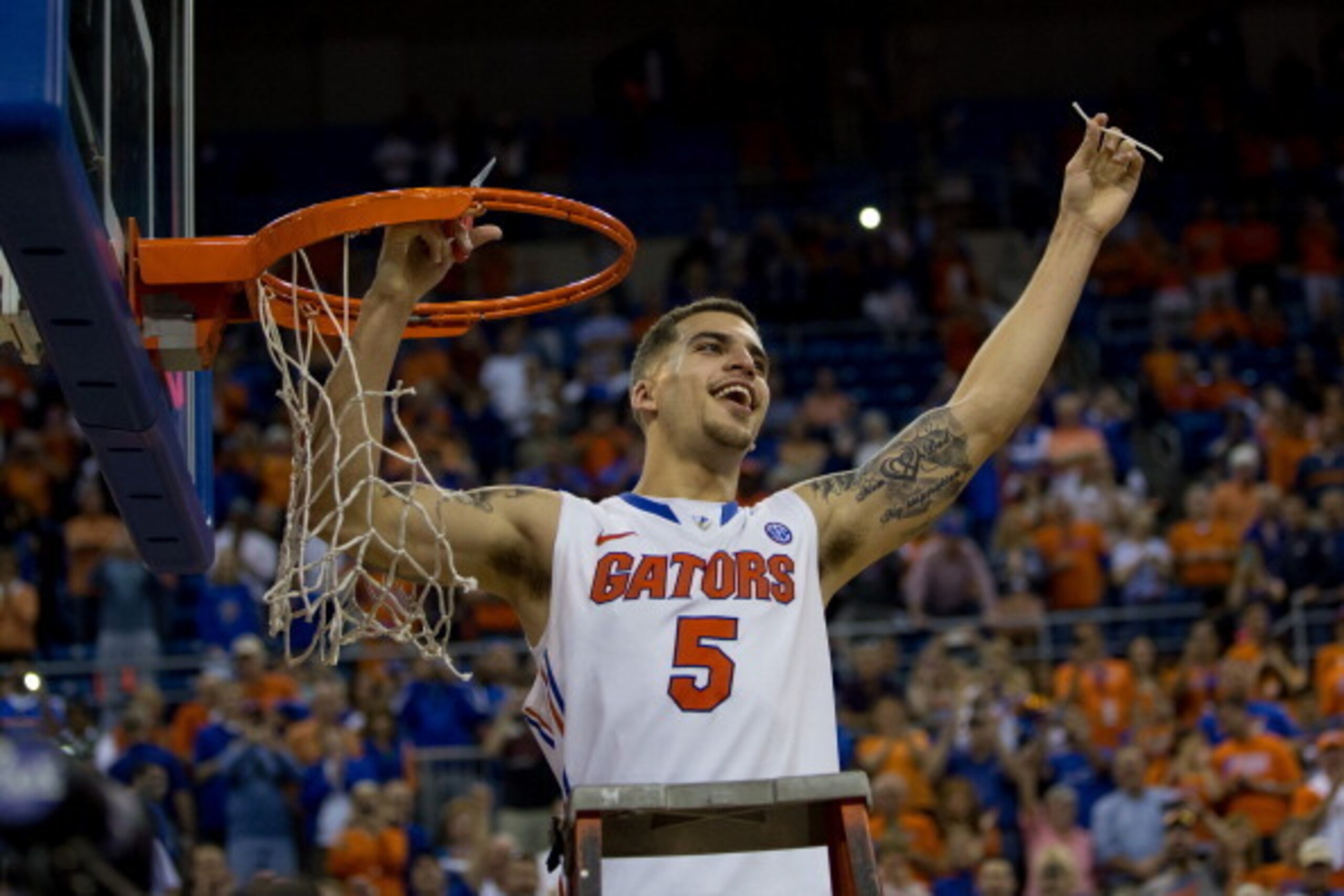 GAINESVILLE, FL - MARCH 08: Scottie Wilbekin #5 of the Florida Gators holds up a piece of the net after the game against the Kentucky Wildcats at the Stephen C. O'Connell Center on March 8, 2014 in Gainesville, Florida. The Gators were 18-0 in the SEC Con