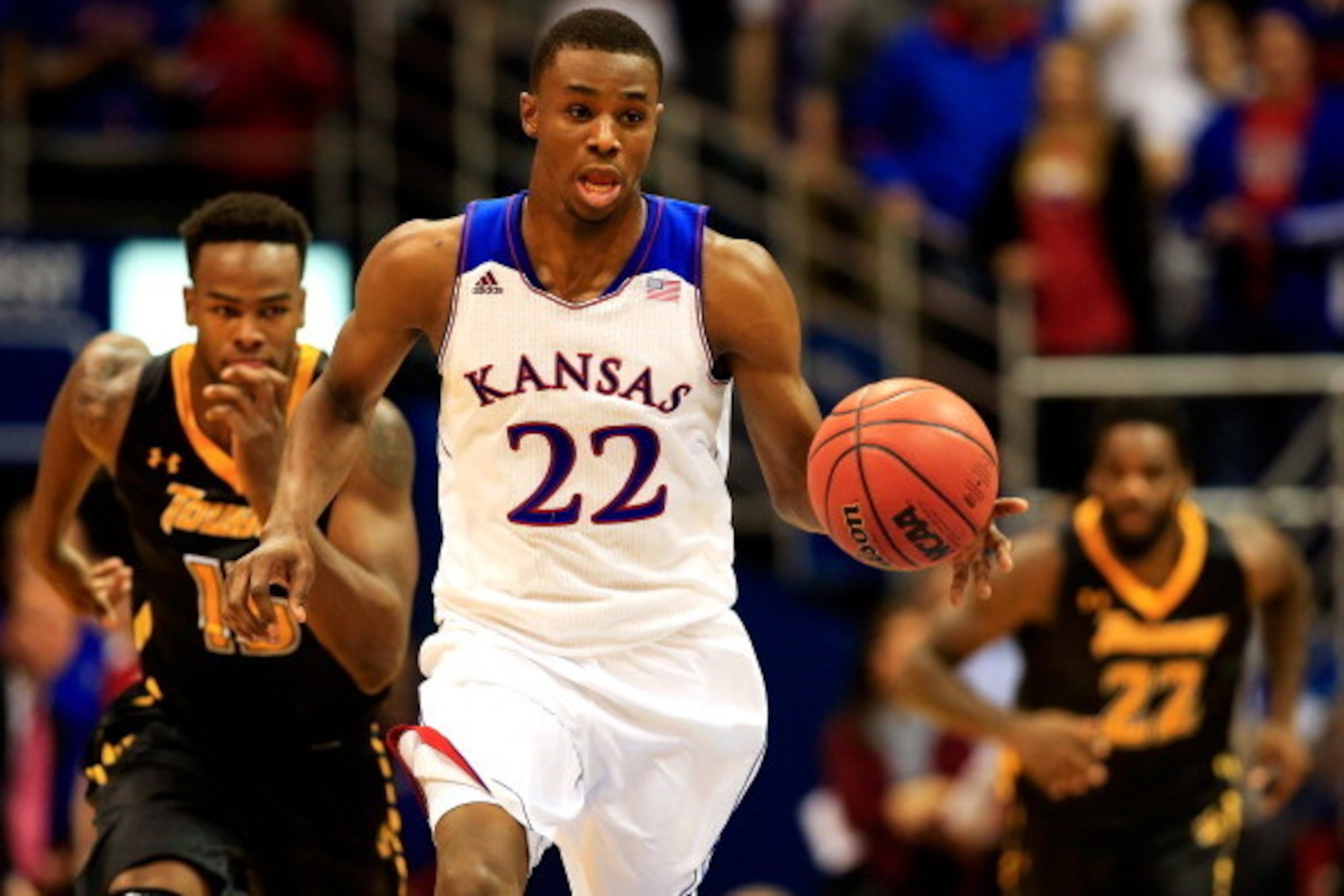 LAWRENCE, KS - NOVEMBER 22: Andrew Wiggins #22 of the Kansas Jayhawks drives upcourt on a fast break as Timajh Parker-Rivera #15 and Rafriel Guthrie #22 of the Towson Tigers chase during the game at Allen Fieldhouse on November 22, 2013 in Lawrence, Kansa