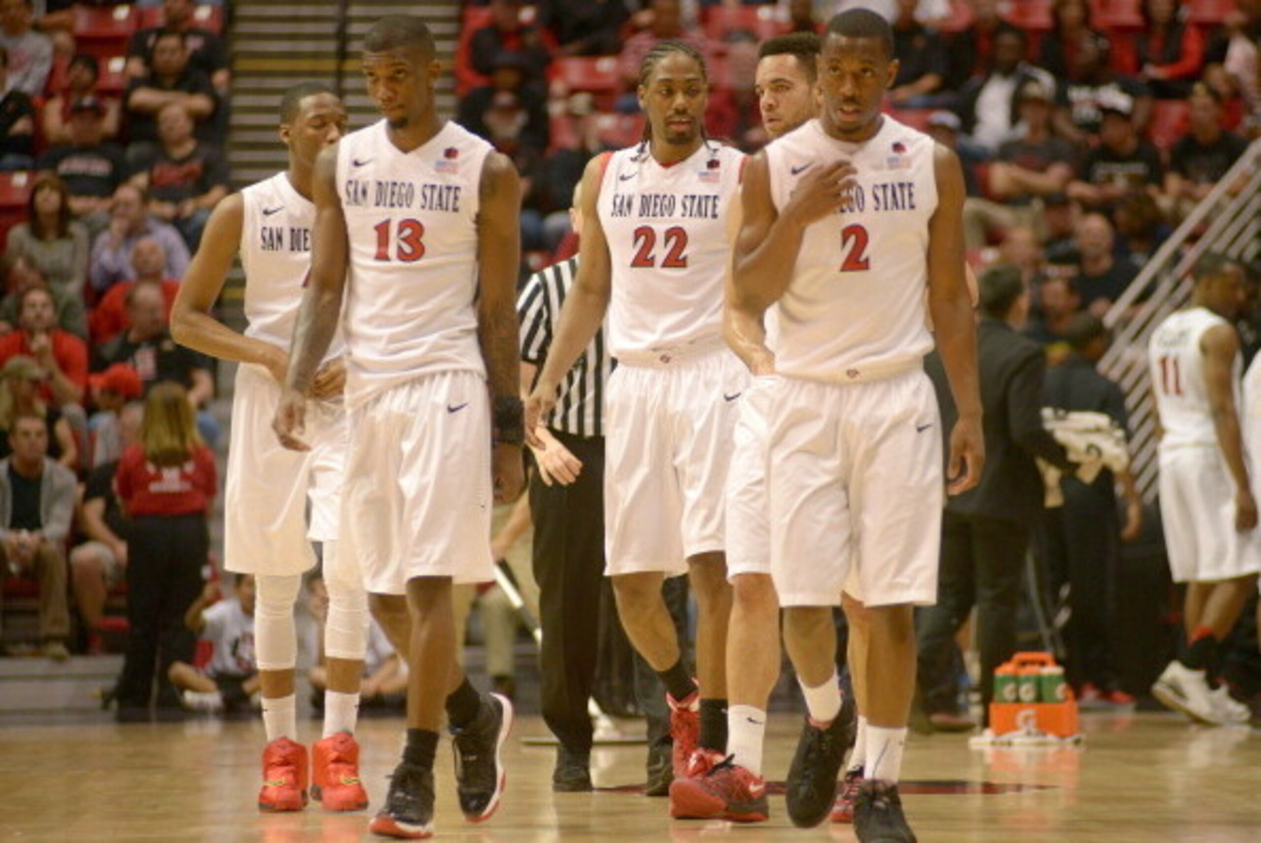 SAN DIEGO, CA - FEBRUARY 15:  Winston Shepard #13, Josh Davis #22 and Xavier Thames #2 of the San Diego State Aztecs lead their team back onto the court after a time-out in the first half of the game against the Air Force Falcons at the Viejas Arena on Fe