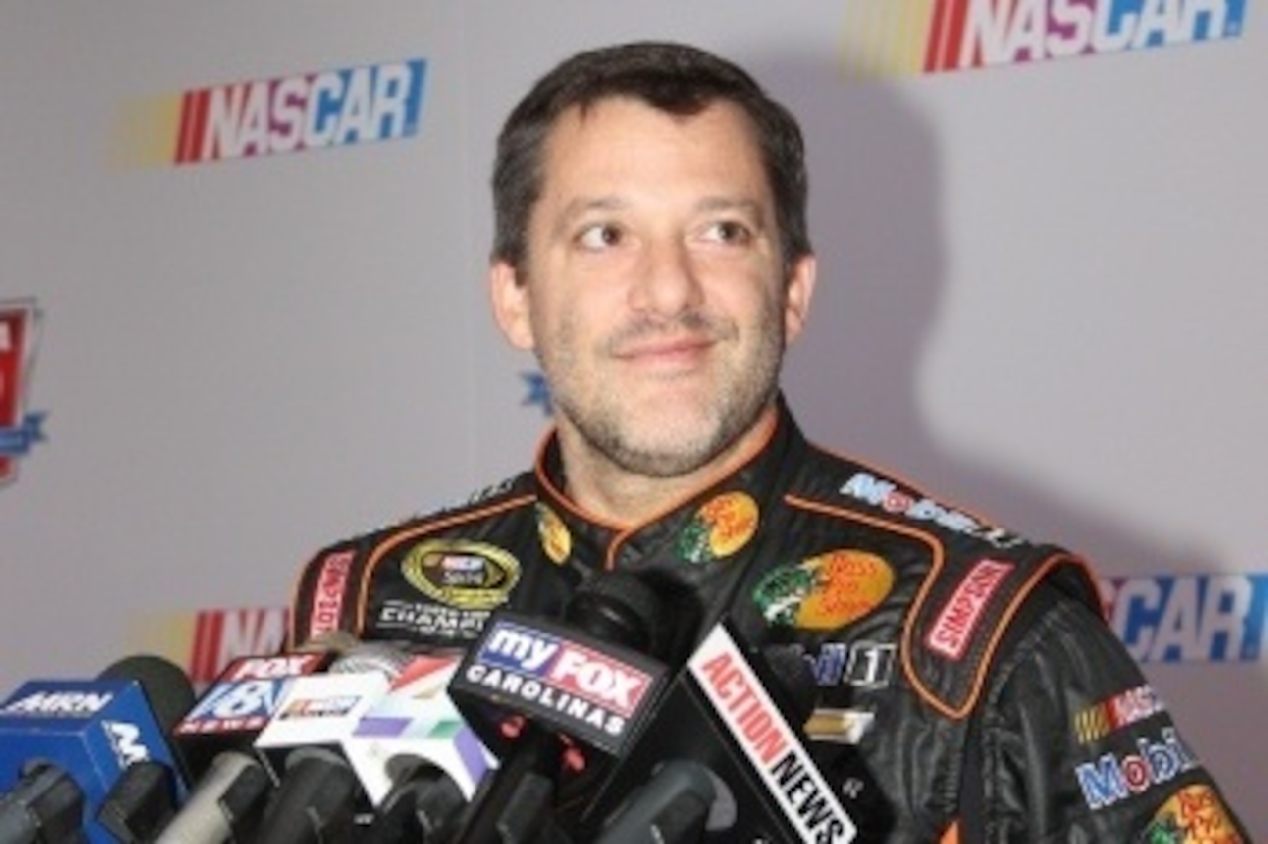 Tony Stewart smiles between questions at NASCAr Daytona Media Day