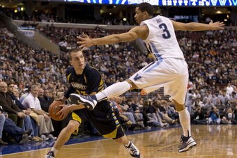 PHILADELPHIA, PA - MARCH 2: Guard Jake Thomas #23 of the Marquette Golden Bears attempts to pass with ball with guard Josh Hart #3 of the Villanova WIldcats defending on March 2, 2014 at the Wells Fargo Center in Philadelphia, Pennslyvania. (Photo by Mitc