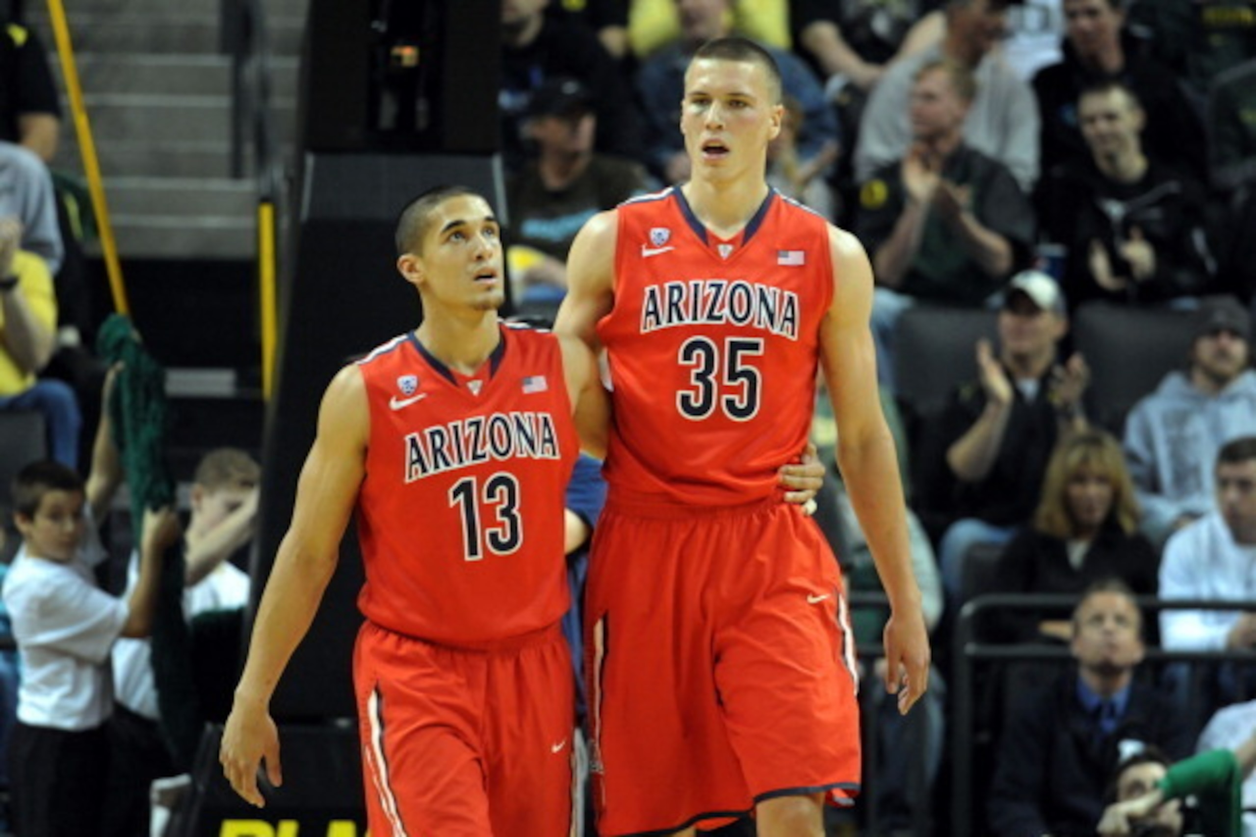 EUGENE, OR - MARCH 8: Nick Johnson #13 and Kaleb Tarczewski #35 of the Arizona Wildcats walk off the court during the second half of the game against the Oregon Ducks at Matthew Knight Arena on March 8, 2014 in Eugene, Oregon. Oregon won the game 64-57. (