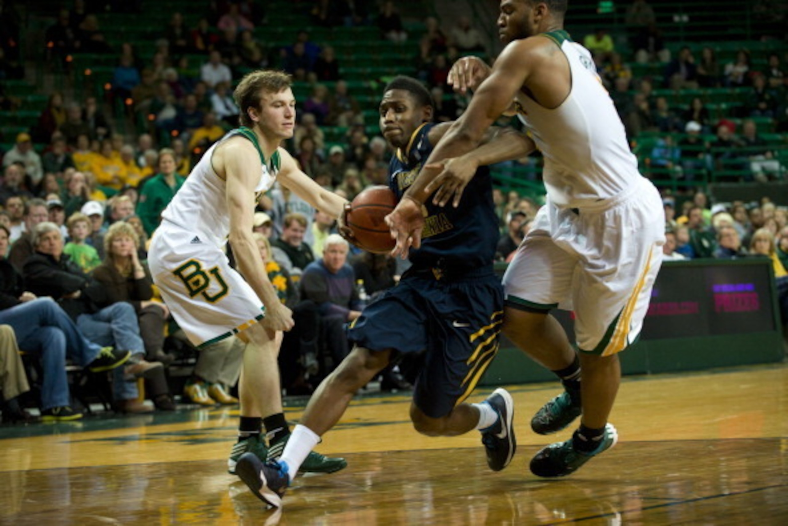 WACO, TX - JANUARY 28:  Juwan Staten #3 of the West Virginia Mountaineers drives to the basket past Brady Heslip #5 and Rico Gathers #2 of the Baylor Bears on January 28, 2014 at the Ferrell Center in Waco, Texas.  (Photo by Cooper Neill/Getty Images)