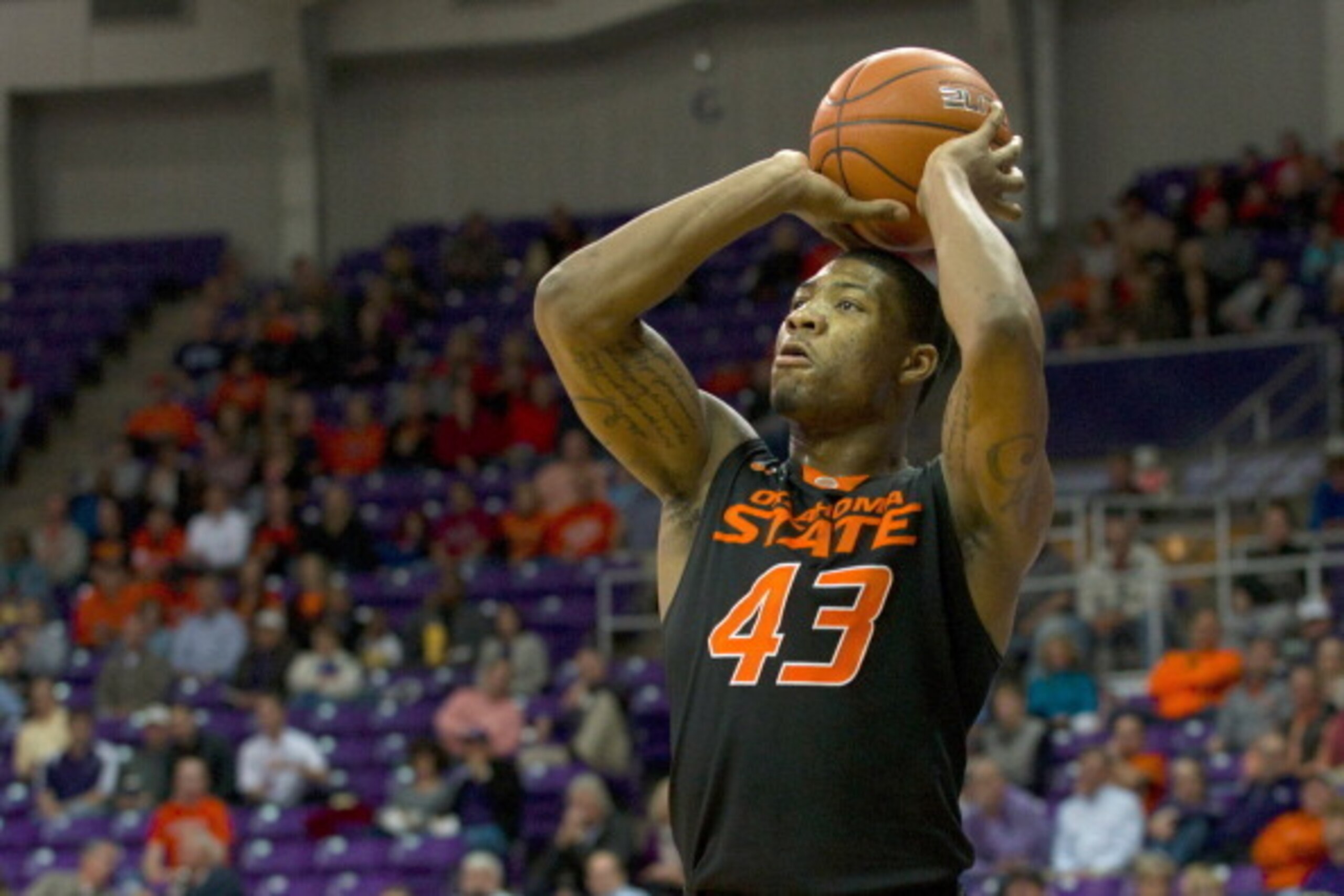 FORT WORTH, TX - FEBRUARY 24: Marcus Smart #43 of the Oklahoma State Cowboys shoots a three-pointer against the TCU Horned Frogs on February 24, 2014 at Daniel-Meyer Coliseum in Fort Worth, Texas.  (Photo by Cooper Neill/Getty Images)
