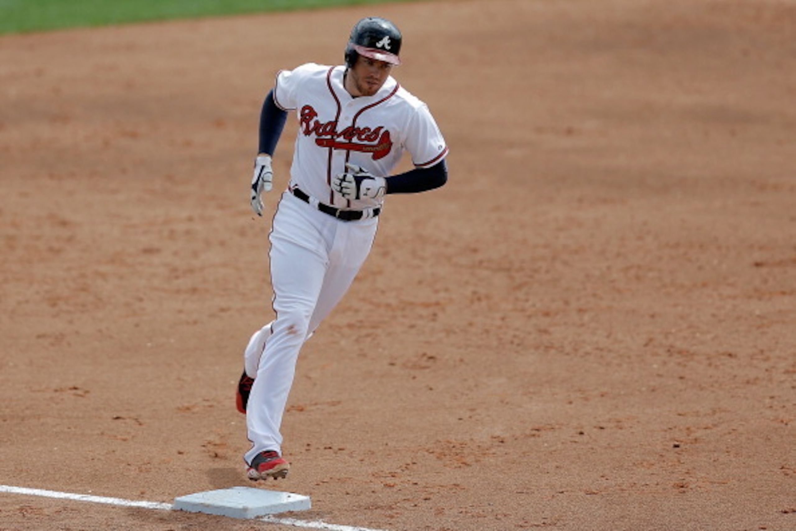 LAKE BUENA VISTA, FL - MARCH 12:  Freddie Freeman #5 of the Atlanta Braves touches third base following a third inning homerun against the Washington Nationals during a game at Champion Stadium on March 12, 2014 in Lake Buena Vista, Florida.  (Photo by St
