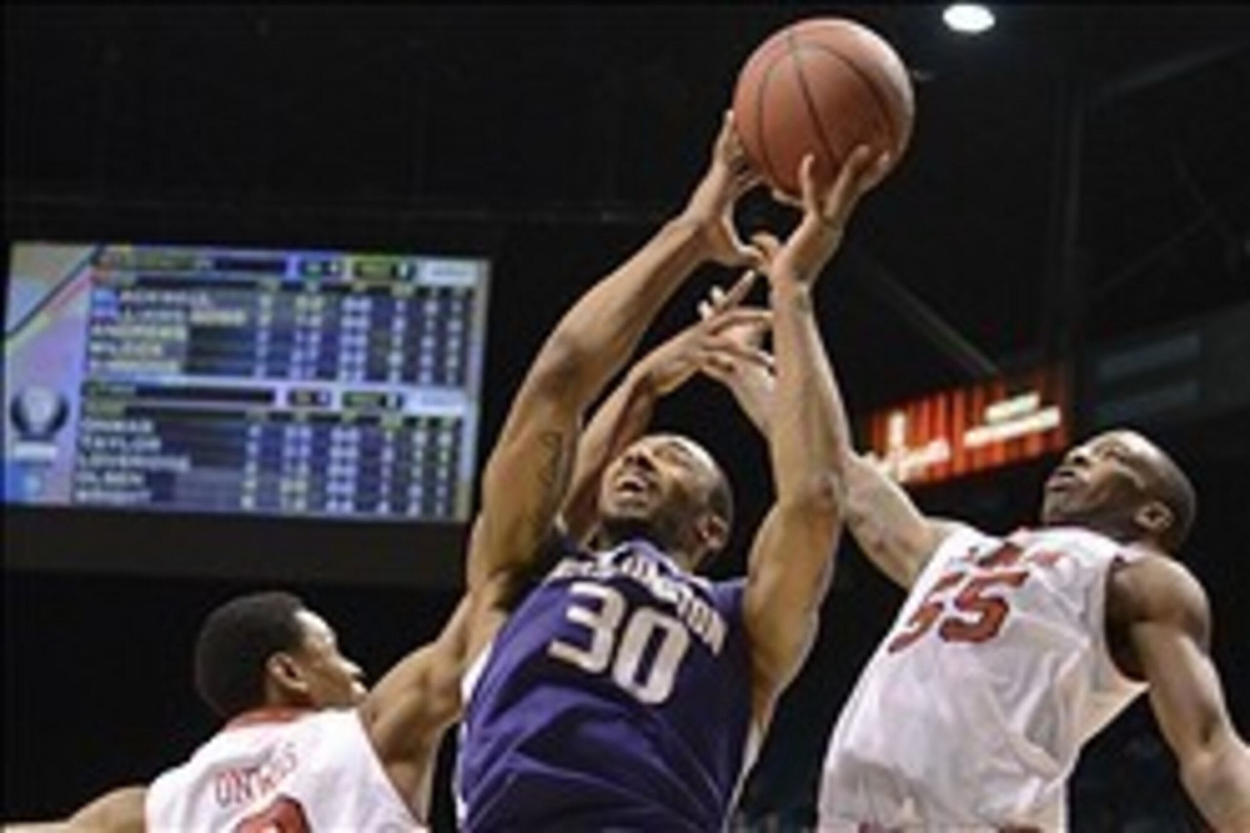 Mar 12, 2014; Las Vegas, NV, USA; Washington Huskies forward Desmond Simmons (30) shoots against Utah Utes guard/forward Princeton Onwas (3) and guard Delon Wright (55) during the first half in the first round of the Pac-12 Conference Tournament at MGM Gr