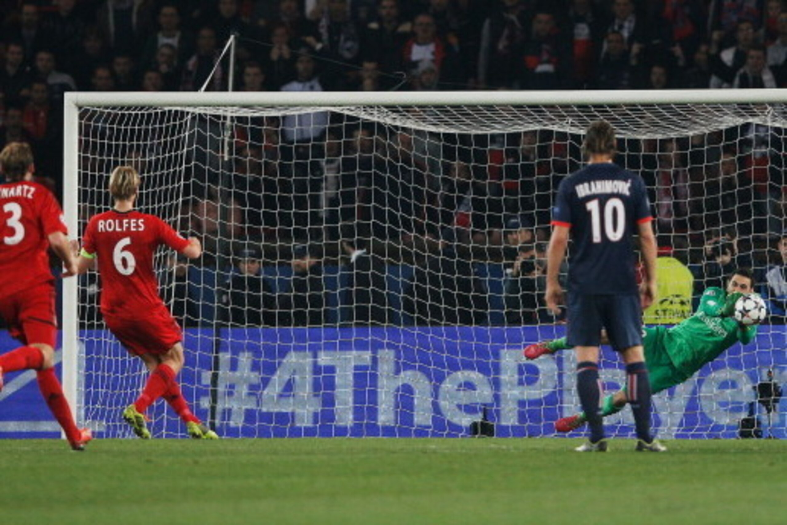 PARIS, FRANCE - MARCH 12:  Salvatore Sirigu of Paris Saint-Germain saves a penalty from Simon Rolfes of Bayer Leverkusen (6) during the UEFA Champions League Round of 16 second leg match between Paris Saint-Germain FC and Bayer Leverkusen at Parc des Prin