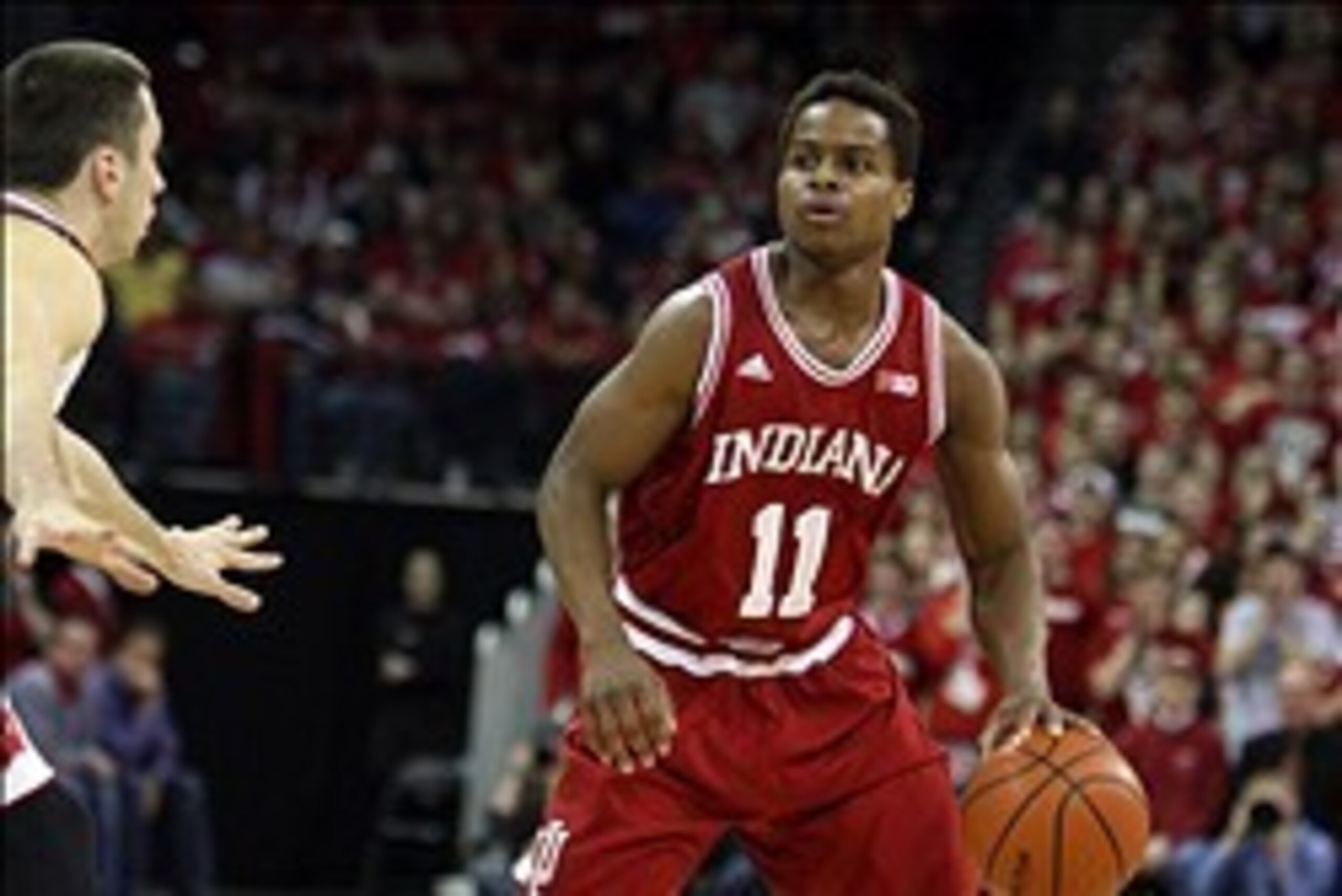 Feb 25, 2014; Madison, WI, USA;  Indiana Hoosiers guard Yogi Ferrell (11) looks to pass as Wisconsin Badgers guard Josh Gasser defends at the Kohl Center. Wisconsin defeated Indiana 69-58. Mandatory Credit: Mary Langenfeld-USA TODAY Sports