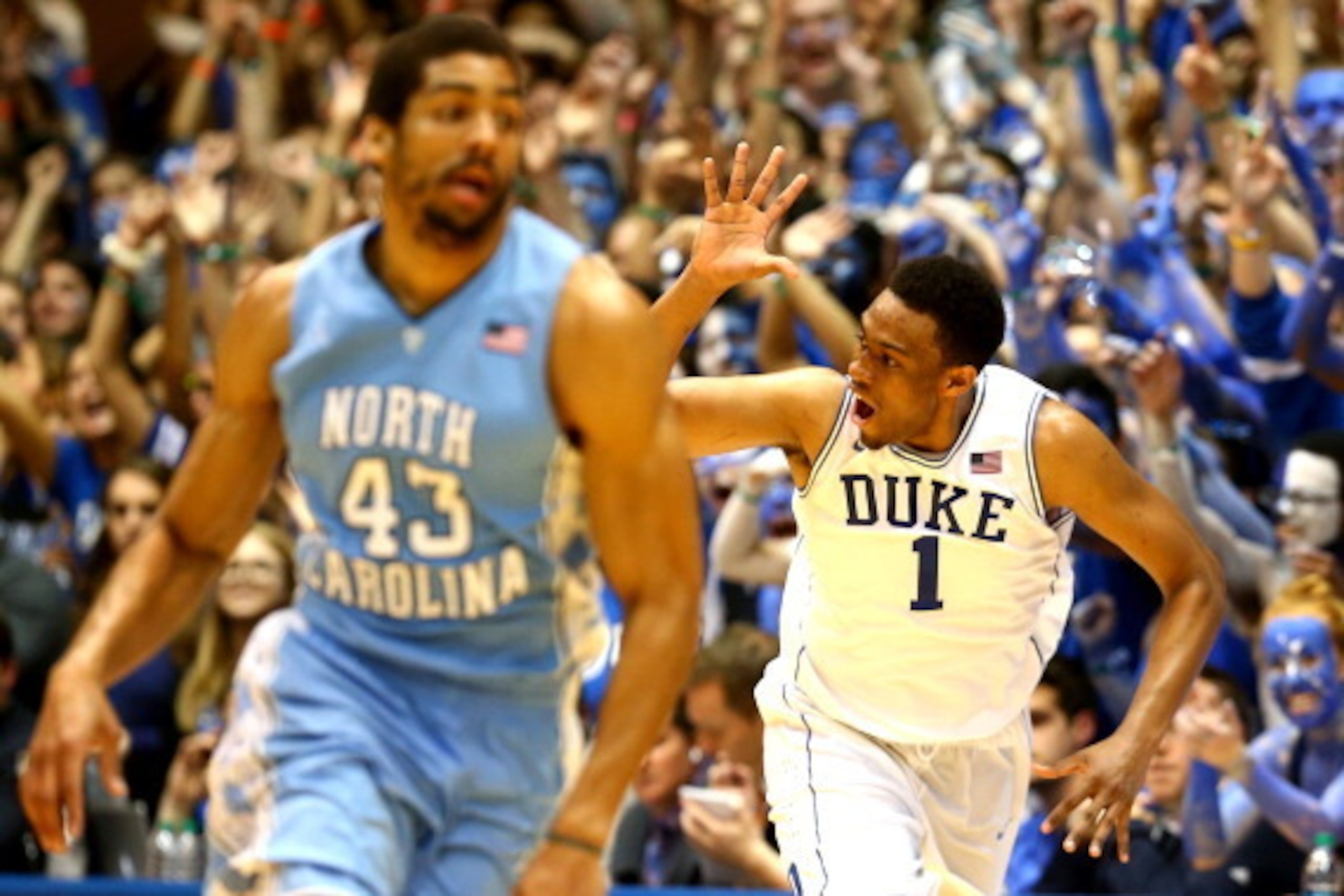 DURHAM, NC - MARCH 08: James Michael McAdoo #43 of the North Carolina Tar Heels wtaches as Jabari Parker #1 of the Duke Blue Devils reacts after making a basket during their game at Cameron Indoor Stadium on March 8, 2014 in Durham, North Carolina. (Pho DURHAM, NC - MARCH 08: James Michael McAdoo #43 of the North Carolina Tar Heels wtaches as Jabari Parker #1 of the Duke Blue Devils reacts after making a basket during their game at Cameron Indoor Stadium on March 8, 2014 in Durham, North Carolina. (Pho