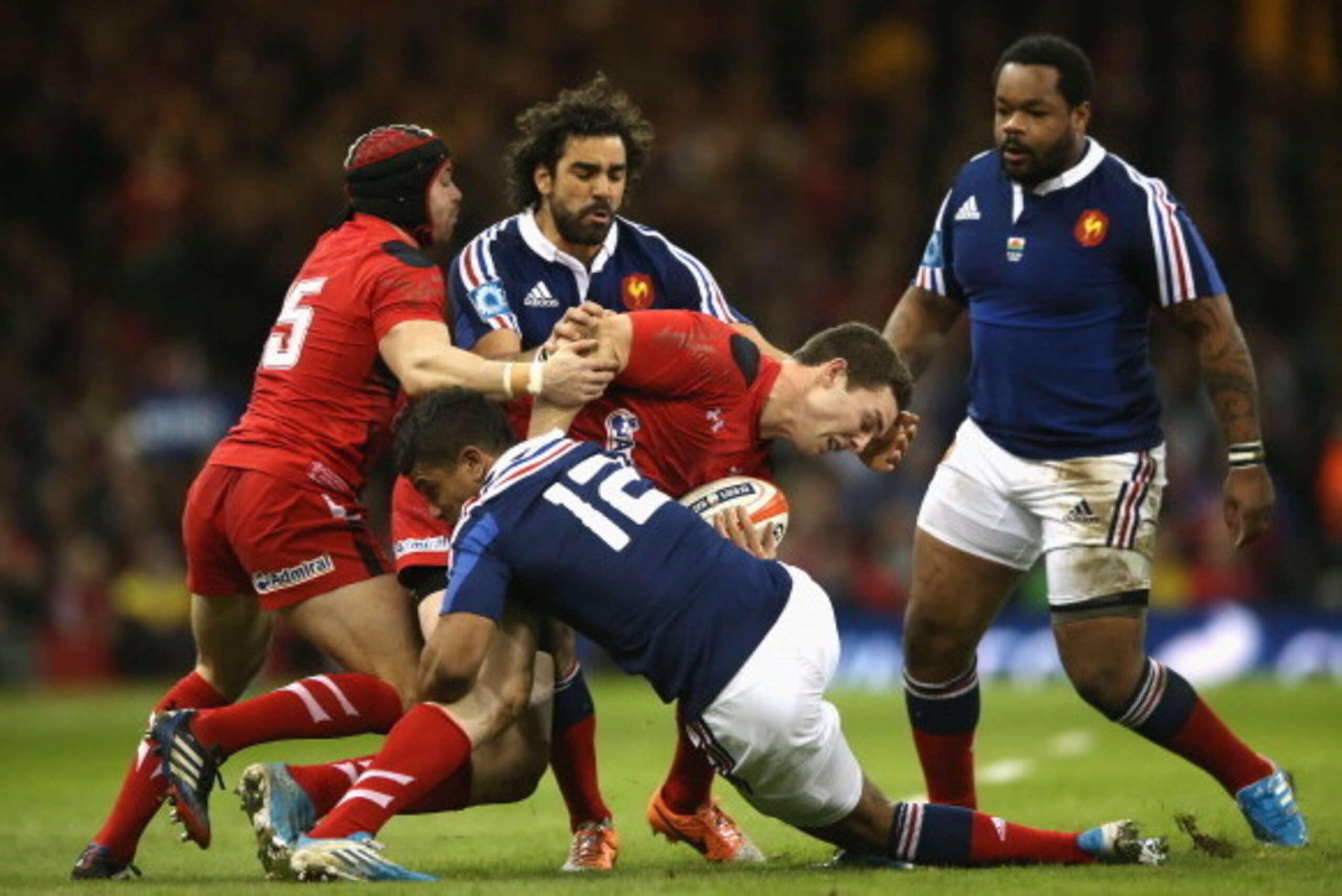 CARDIFF, WALES - FEBRUARY 21:  George North of Wales is tackled by Yoann Huget and Wesley Fofana (12) during the RBS Six Nations match between Wales and France at the Millennium Stadium on February 21, 2014 in Cardiff, Wales.  (Photo by David Rogers/Getty