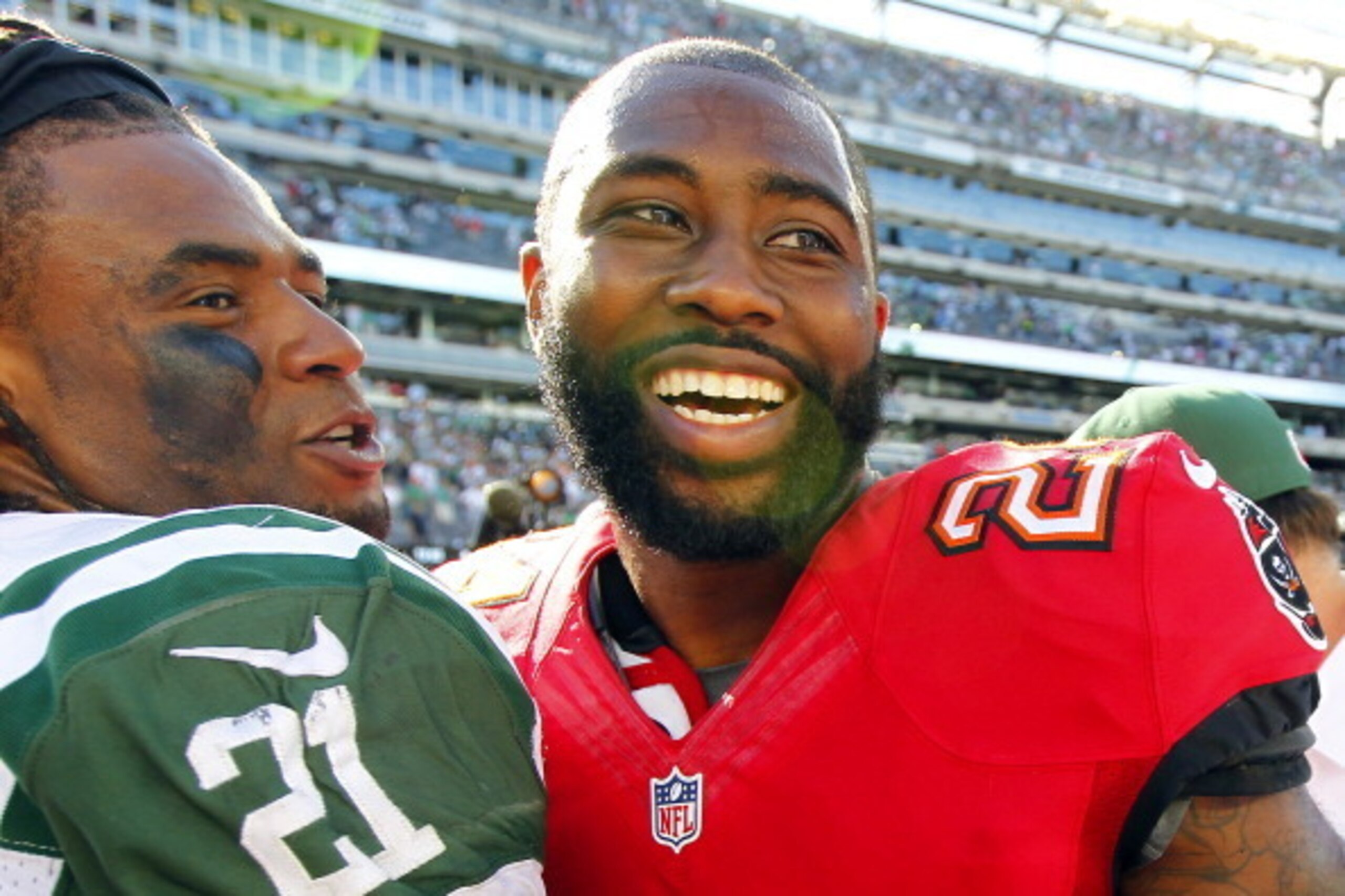 EAST RUTHERFORD, NJ - SEPTEMBER 8: Corner back Ellis Lankster #21 of the New York Jets laughs with former teammate cornerback Darrelle Revis #24 of the Tampa Bay Buccaneers after their game at MetLife Stadium on September 8, 2013 in East Rutherford, New J