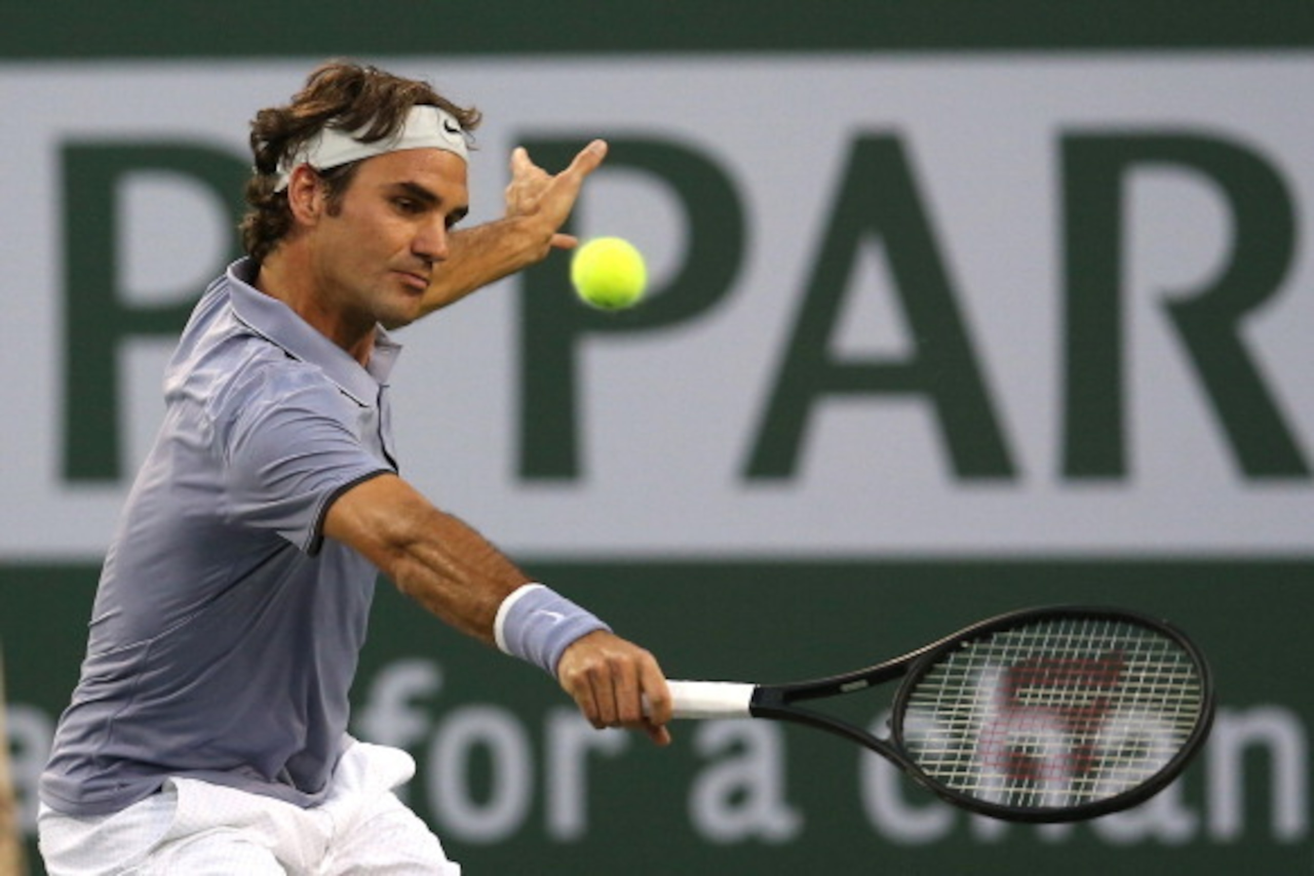 INDIAN WELLS, CA - MARCH 12:  Roger Federer of Switzerland hits a return to Tommy Haas of Germany during the BNP Paribas Open at Indian Wells Tennis Garden on March 12, 2014 in Indian Wells, California.  (Photo by Stephen Dunn/Getty Images)