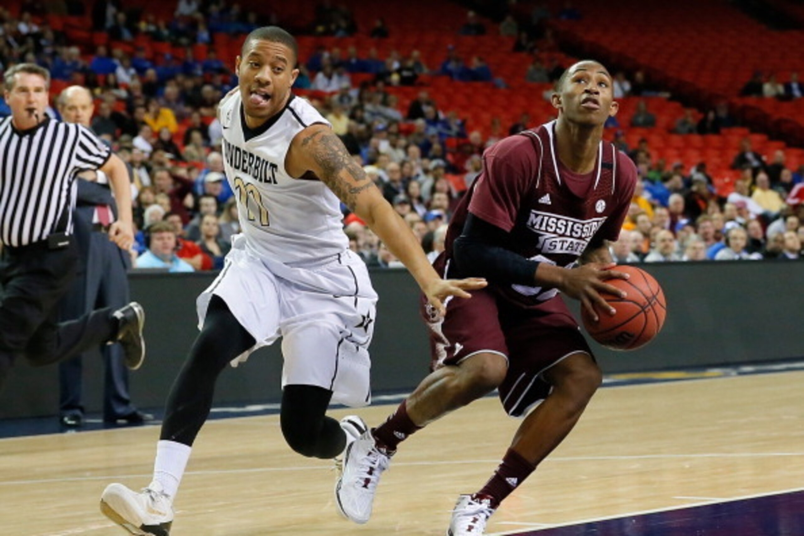 ATLANTA, GA - MARCH 12:  Craig Sword #32 of the Mississippi State Bulldogs drives against Kyle Fuller #11 of the Vanderbilt Commodores during the first round of the SEC Men's Basketball Tournament at Georgia Dome on March 12, 2014 in Atlanta, Georgia.  (P