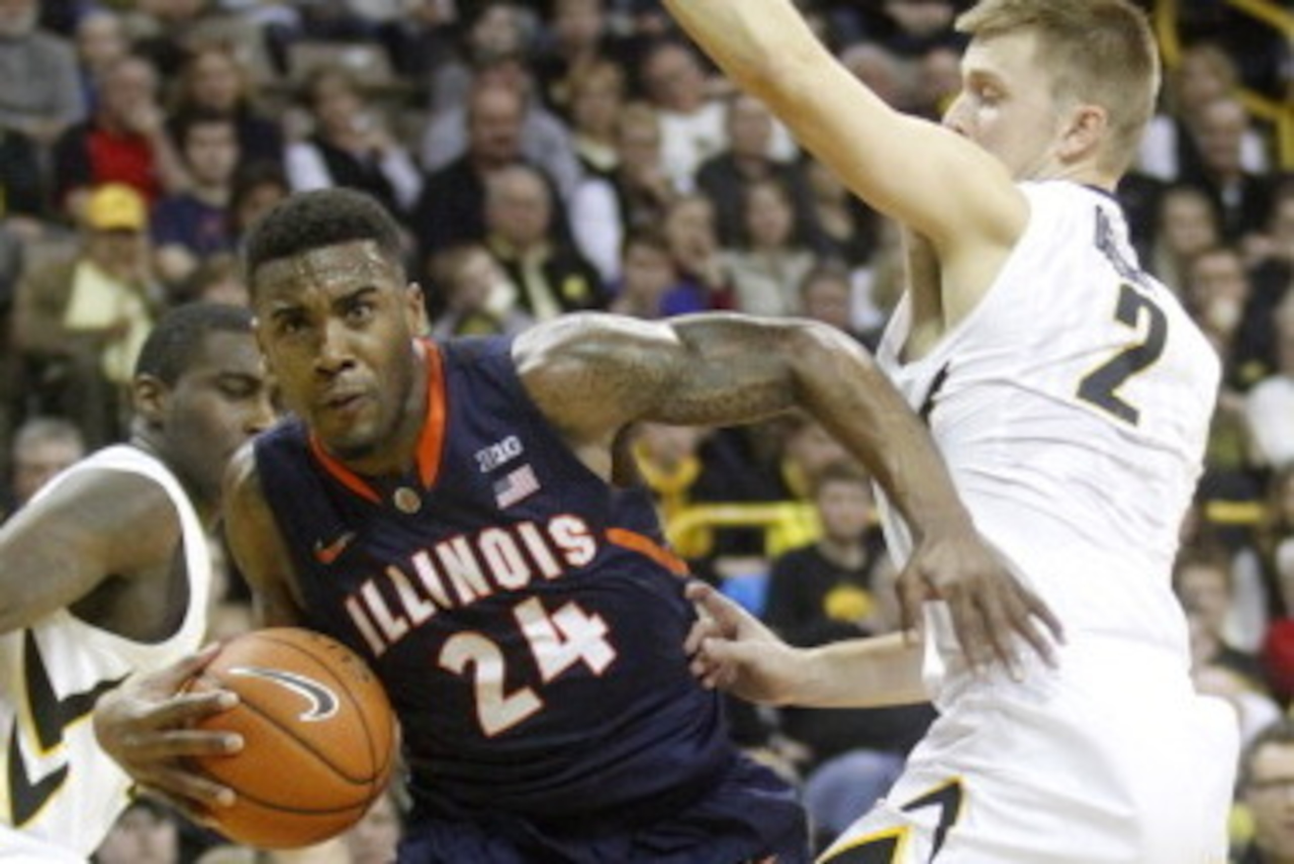 IOWA CITY, IA - MARCH 8:  Guard Rayvonte Rice #24 of the Illinois Fighting Illini goes to the basket during the first half in front of guard Josh Oglesby #2 of the Iowa Hawkeyes on March 8, 2014 at Carver-Hawkeye Arena, in Iowa City, Iowa. (Photo by Matth