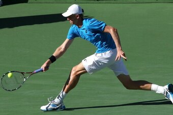 INDIAN WELLS, CA - MARCH 12:  Kevin Anderson of South Africa hits a return to Stanislas Wawrinka of Switzerland during the BNP Paribas Open at Indian Wells Tennis Garden on March 12, 2014 in Indian Wells, California.  (Photo by Stephen Dunn/Getty Images)