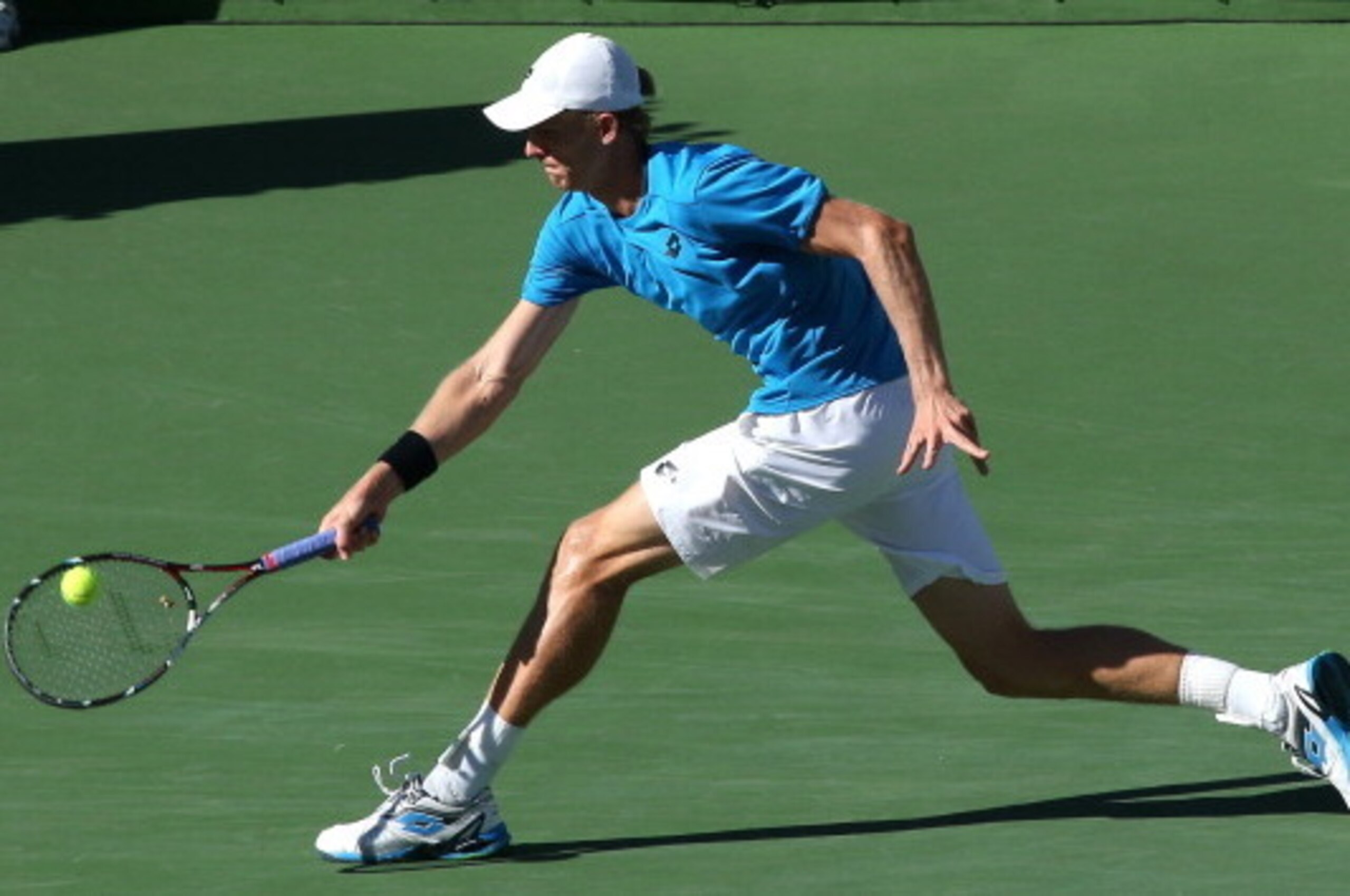 INDIAN WELLS, CA - MARCH 12:  Kevin Anderson of South Africa hits a return to Stanislas Wawrinka of Switzerland during the BNP Paribas Open at Indian Wells Tennis Garden on March 12, 2014 in Indian Wells, California.  (Photo by Stephen Dunn/Getty Images)